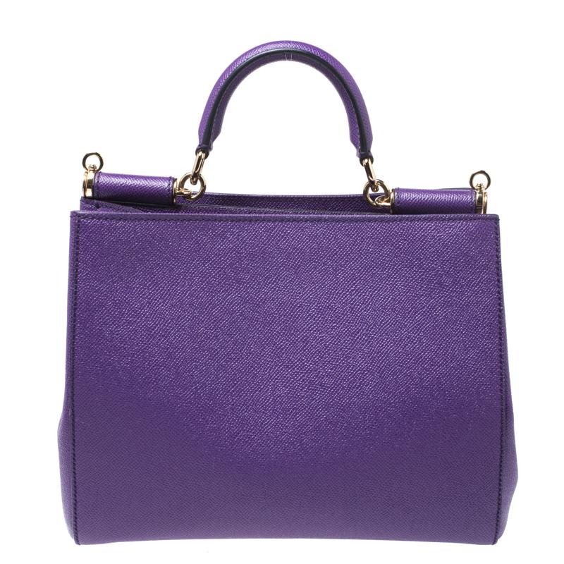 This gorgeous purple Miss Sicily bag from Dolce & Gabbana is a lovely piece. It has a well-structured design and a top that opens to a fabric interior with enough space to fit your essentials. The bag comes with gold-tone hardware, a top handle, a