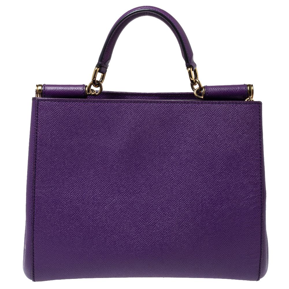 This gorgeous purple Miss Sicily bag from Dolce & Gabbana is a handbag coveted by women around the world. It has a well-designed exterior. The bag opens to a compartment with satin lining and enough space to fit your essentials. It comes with