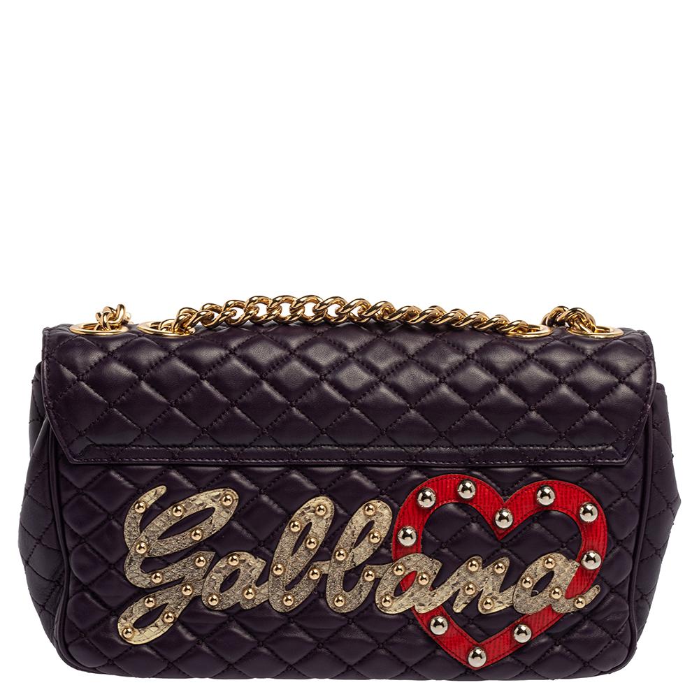 Dolce & Gabbana's Lucia bag has been crafted in Italy from leather in a quilted style. It is beautifully decorated with DOLCE appliques on the front and GABBANA at the back, both embellished with studs and spikes. The lock opens to reveal a