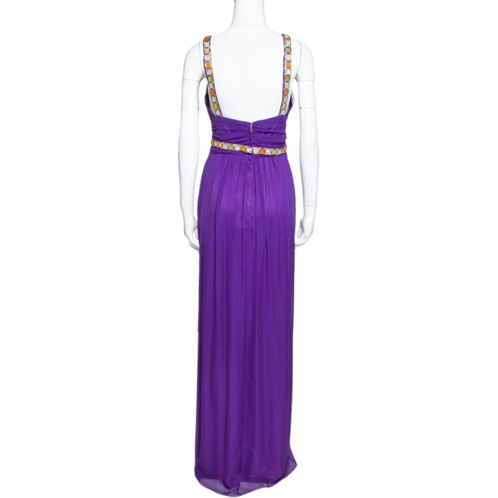 Designed in a flattering silhouette, this silk chiffon maxi number from Dolce & Gabbana is a head-turner! It looks lovely in a purple shade and features ruched details throughout. It flaunts beads and crystals embellished on the waist and the