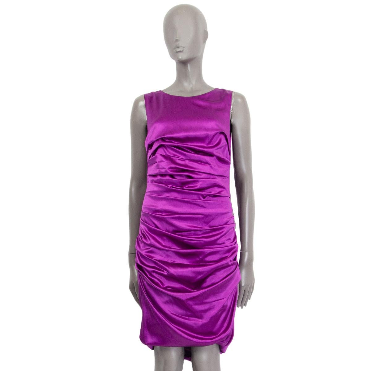 Dolce & Gabbana sleeveless satin ruched dress in orchid purple silk (96%) and elastane (4%) with a round neck. Closes on the back with a zipper. Lined in black silk (90%) and polyester (10%). Has been worn and is in excellent condition. 

Tag Size