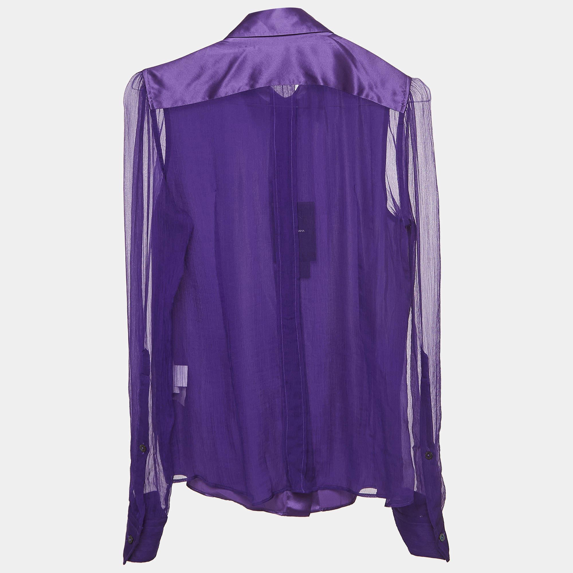 The Dolce & Gabbana shirt is a luxurious piece, crafted from sumptuous silk. This elegant piece features semi-sheer sleeves, adding a touch of sophistication. The rich purple hue enhances its allure, making it a timeless and versatile wardrobe