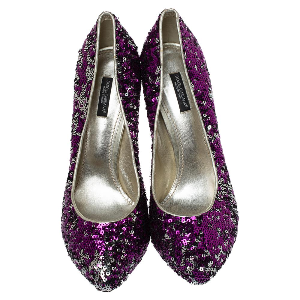 These glitzy pumps by Dolce & Gabbana will assist you in creating a glam and chic look, Crafted from leather in purple and silver hues, these beauties have been covered with sequins for an opulent finish. The almond-toe silhouette is mounted on 13