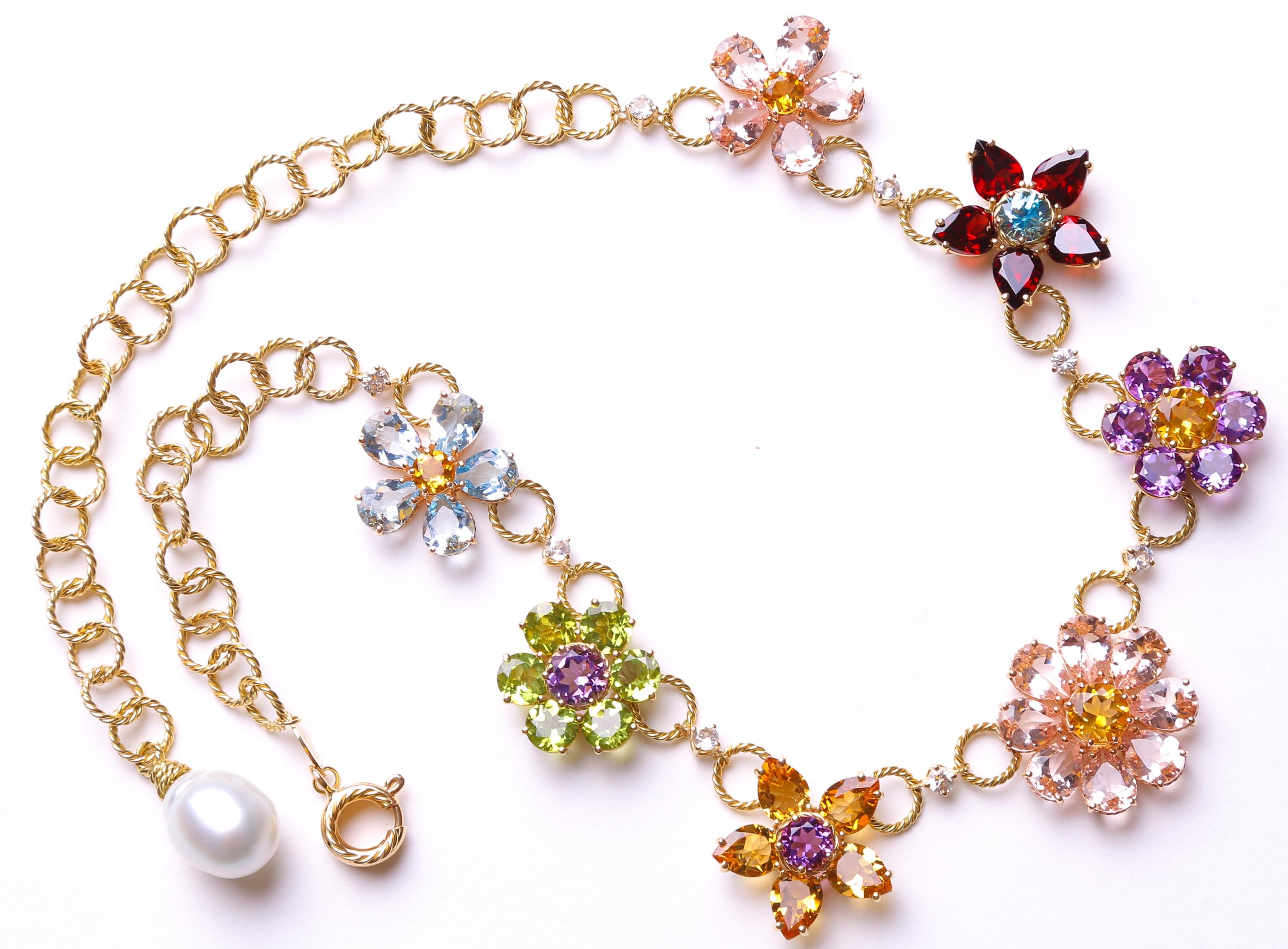  This is not costume jewellery - this is the real thing; a rare multi gem-set floral necklace by Italian Fashion House Dolce & Gabbana. This glorious piece is designed as a graduated series of seven multi-gem floral clusters with colourless sapphire