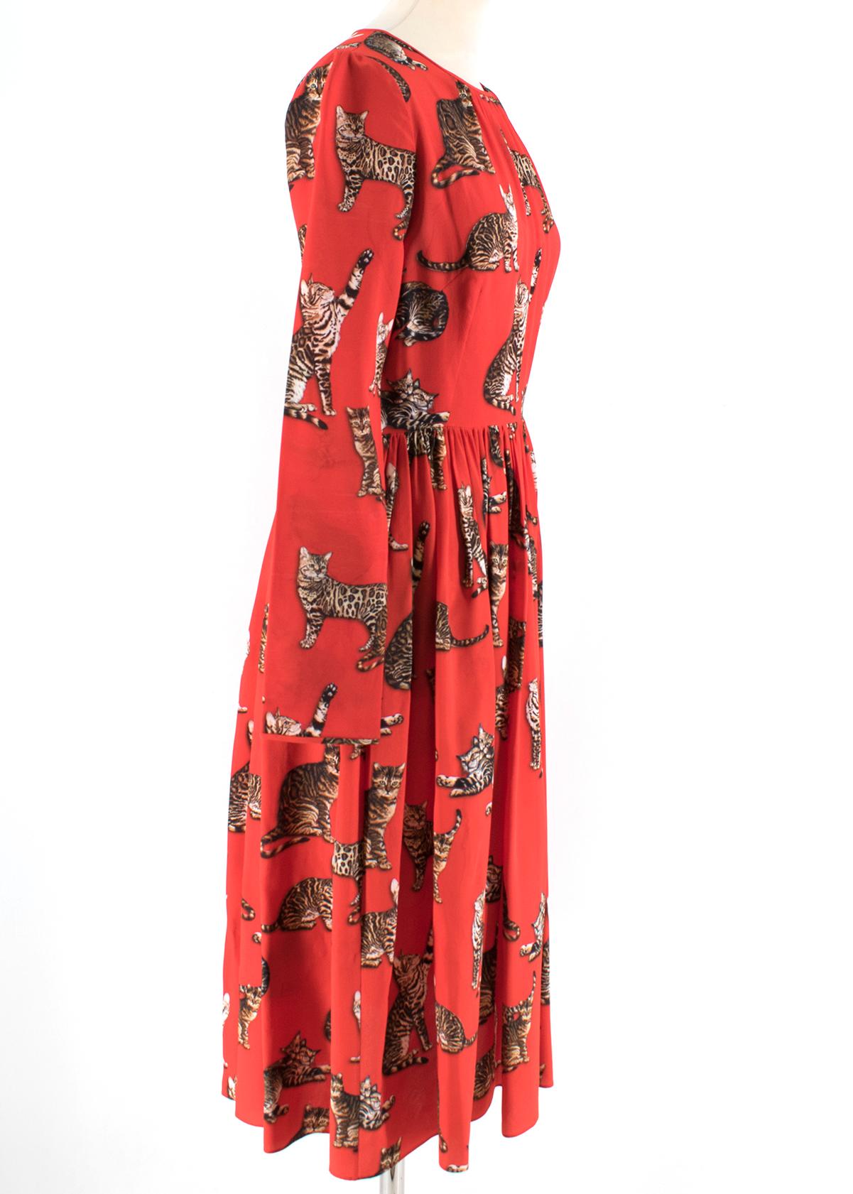 Dolce & Gabbana Red Cat Print Silk Dress 

- Red Cat Print Dress
- 100% Stretch Silk 
- Round neck, long sleeved
- Concealed rear zip fastening
- Pleated skirt, knee length

Please note, these items are pre-owned and may show some signs of storage,