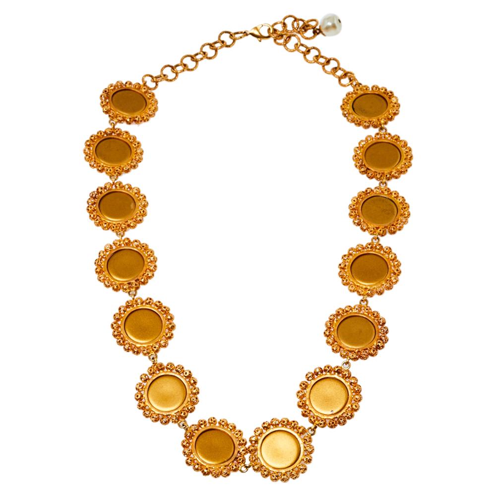 Designs by Dolce & Gabbana are not only well-made but are loaded with wonder and sweetness. This necklace, for example, is so unbelievably pretty. Made from gold-tone metal, the neckpiece has an assembly of crystals. These charming details are all