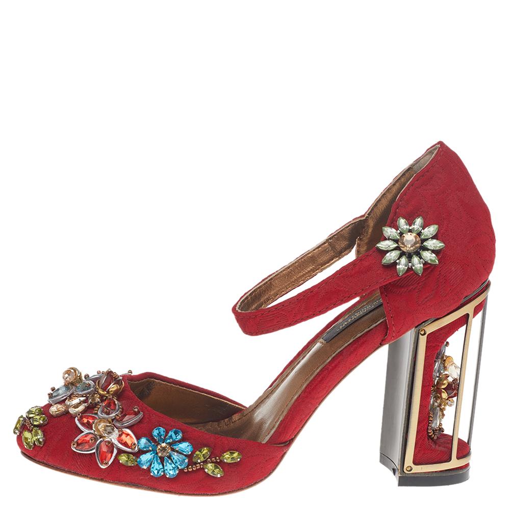 These Dolce & Gabbana Mary Jane pumps will add character to any outfit! Made from red jacquard fabric, they feature gorgeous embellishments all over, a round toe, and straps across the ankles. They have chunky 10 cm heels that are designed lika bird