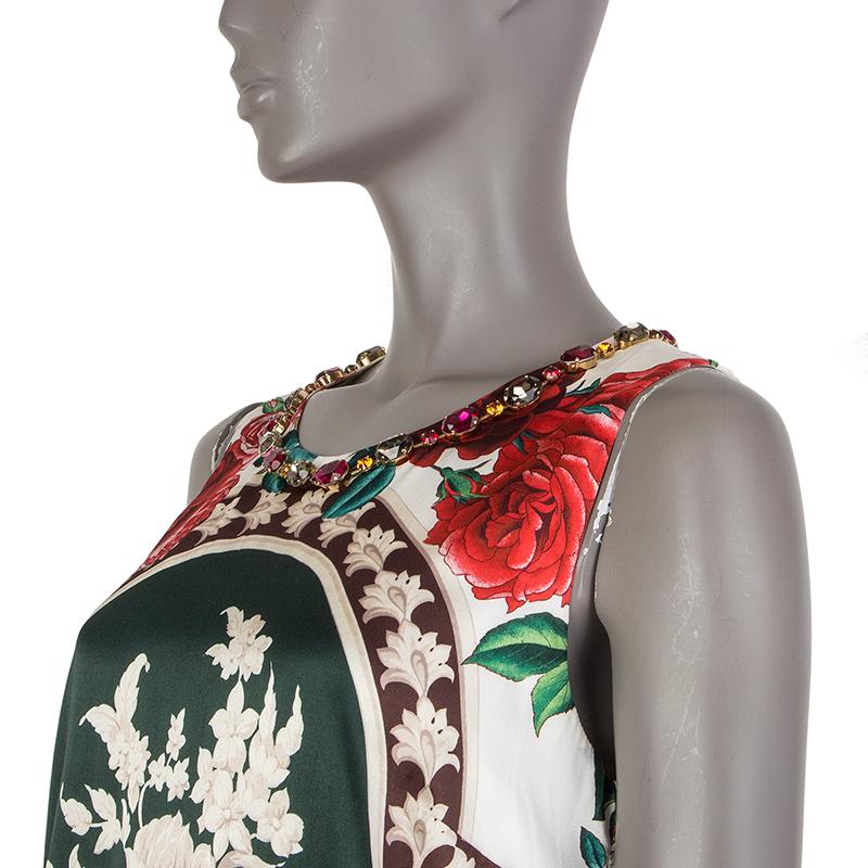 Dolce & Gabbana floral shift dress in red, forest green, maroon, burgundy, off-white, and pine silk (80%), elastane (10%), crystals (8%), and brass ((4%). Closes with snaps on the back. Lined in off-white silk (96%) and elastane (4%). Has been worn