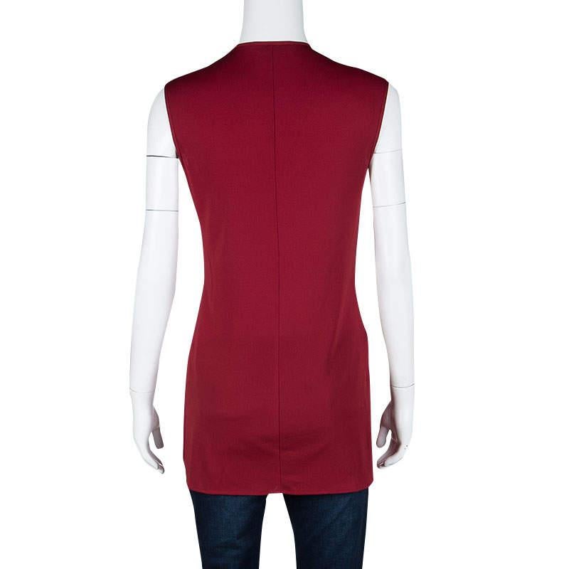 This simple yet stylish tunic from Dolce and Gabbana is designed in a vibrant red knit in a sleeveless pattern. It comes with a V-neckline and looks best when styled with leggings or skinny jeans a coordinating ankle strap sandals.

