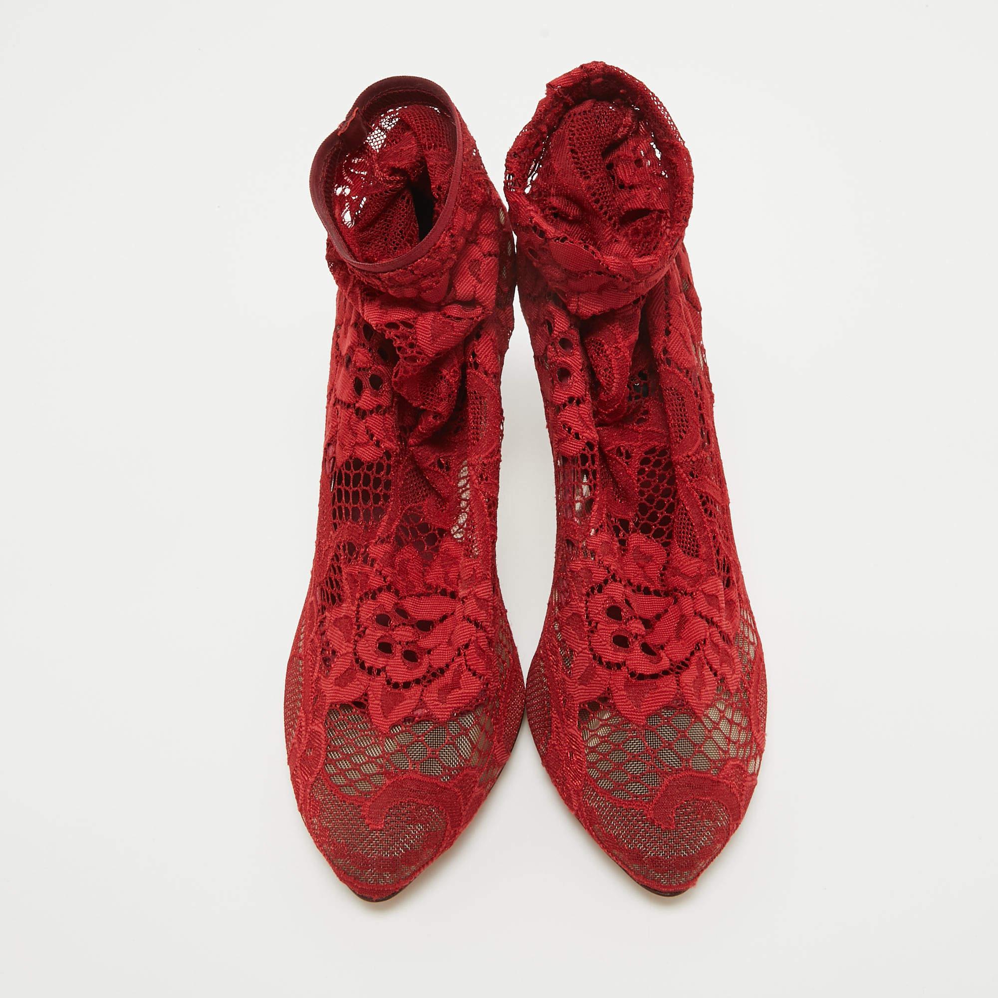 Impeccably crafted into a super-stylish silhouette, these ankle booties from the house of Dolce & Gabbana will help you create a stunning style statement. They are crafted from intricate lace detailing. With an elegant silhouette, the red booties