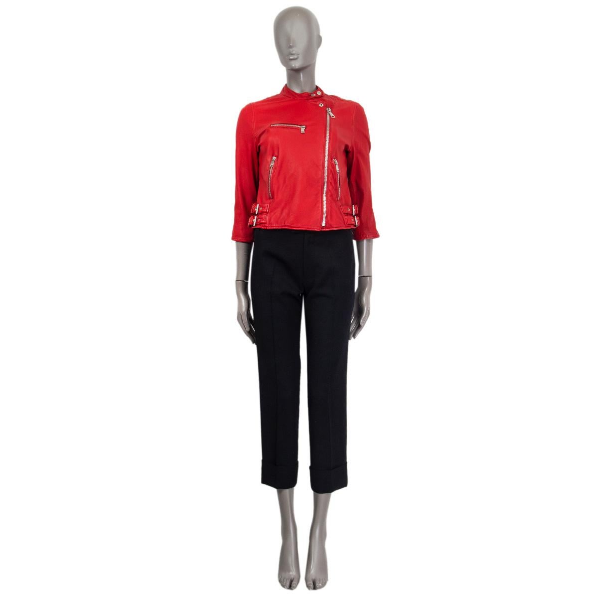 100% authentic Dolce & Gabbana cropped biker jacket in red lambskin (100%). Embellished with zippers at the cuffs, three zip pockets at the front and two buckles on each side. Opens with a silver metal zipper at the front and two snap buttons at the