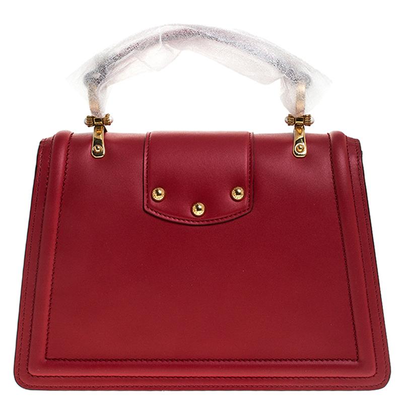 Well-structured and high on style, this DG Amore bag from Dolce & Gabbana deserves to be yours! It has been crafted from red leather and styled with a top handle and a detachable shoulder strap. It also comes with gold-tone embellished logo detail