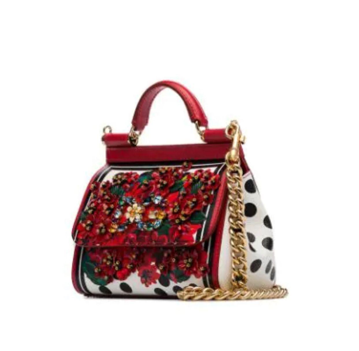 Inspired by the geraniums of Sicilian
gardens and terraces, the Sicily mini
bag is made from printed Dauphine
calfskin which is then hand-
embroidered with multicolored crystals
on the front panel. The print in warm
and vibrant colors and the