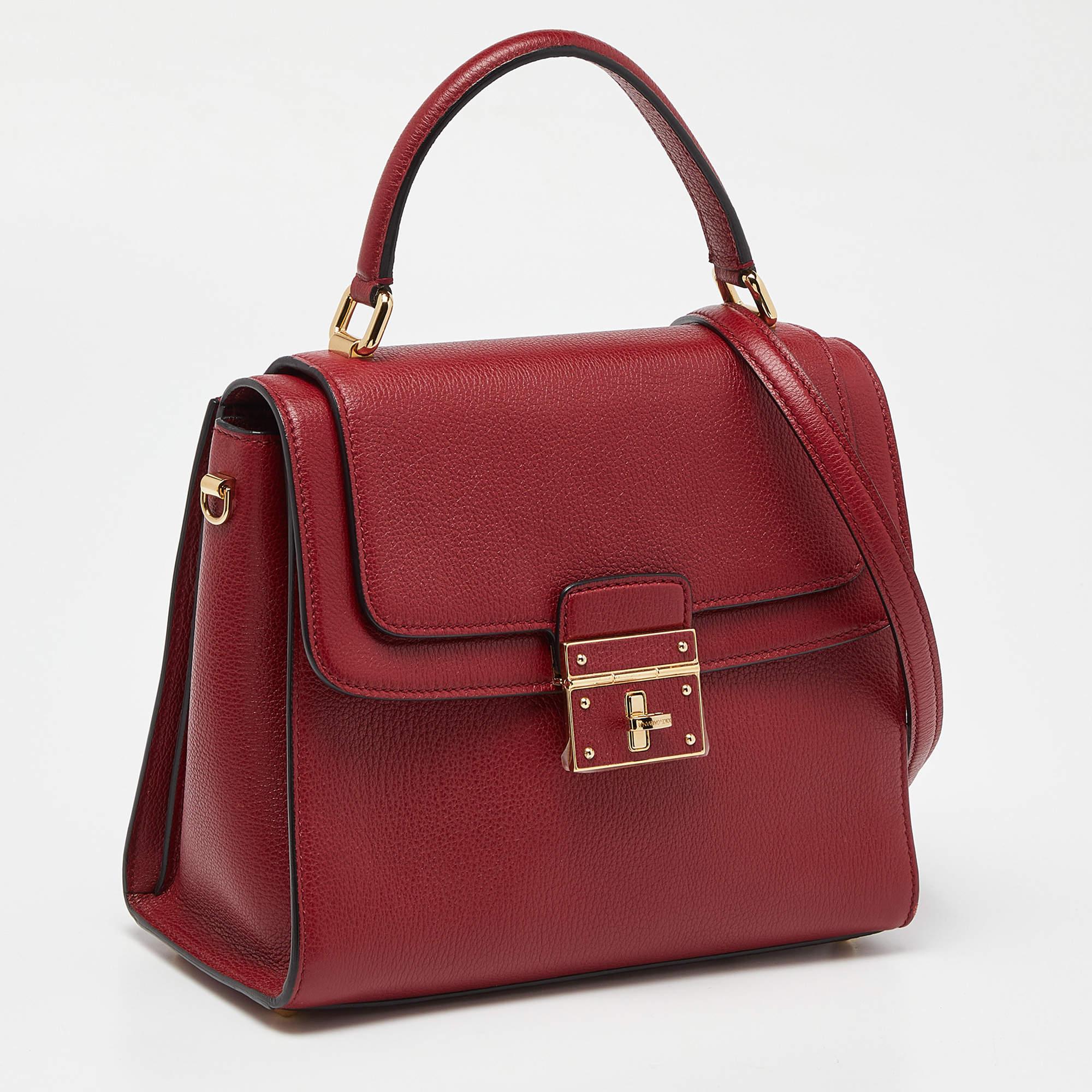 This Dolce & Gabbana bag, made from leather in a gorgeous red, is a picture of sophistication. While the roomy interior offers ample space, the top handle allows you to carry it with much elegance.

