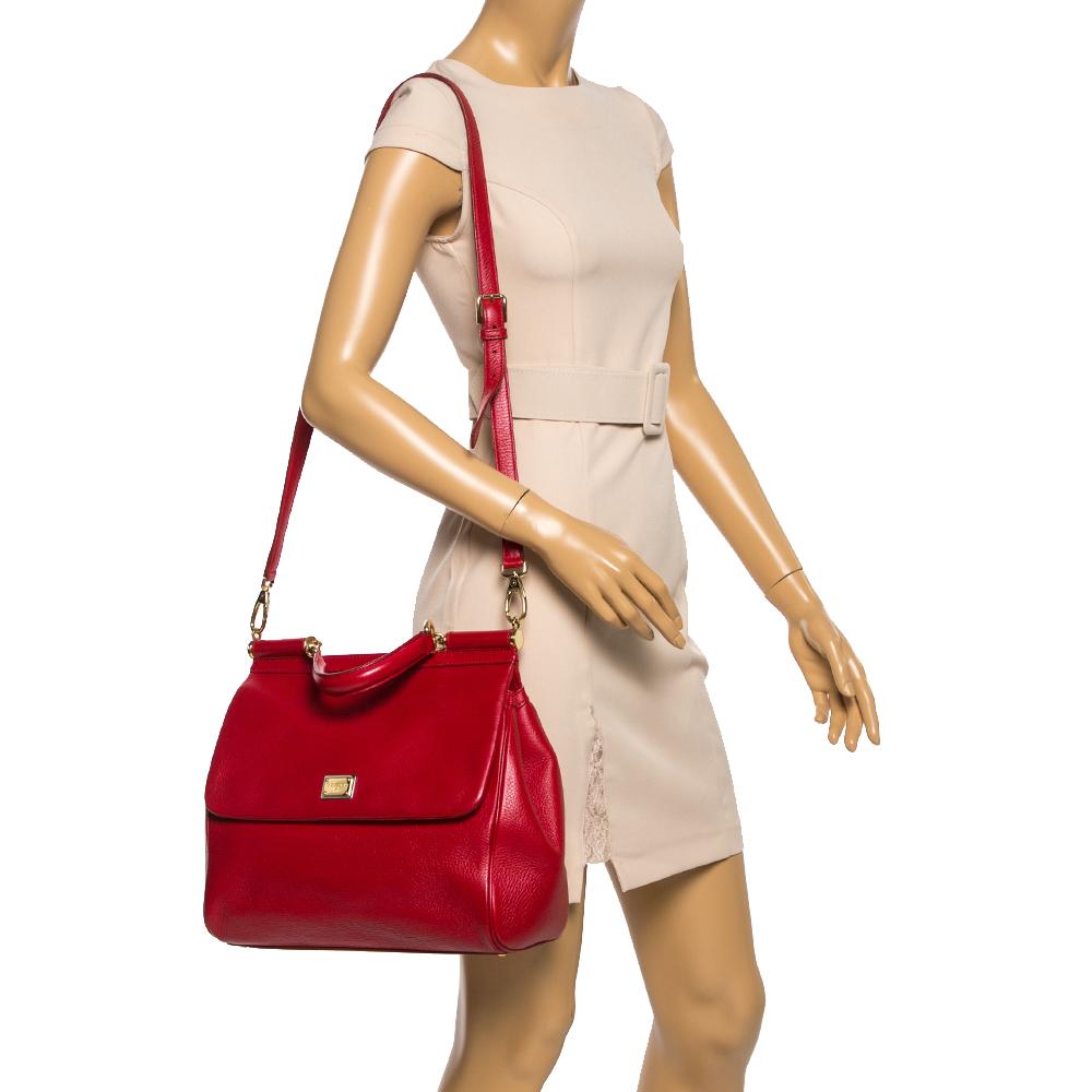 This Miss Sicily from Dolce & Gabbana is a handbag coveted by women around the world. The red leather bag opens to a compartment with fabric lining and enough space to fit your essentials. It comes with gold-tone hardware, a top handle, and a