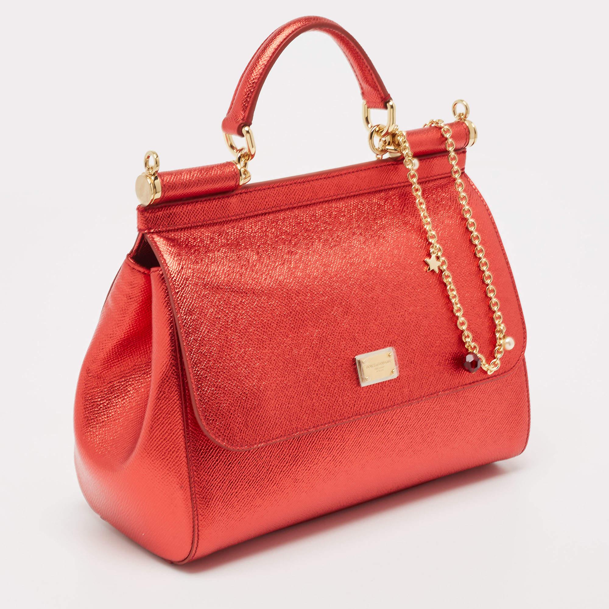 The iconic Miss Sicily bag by Dolce & Gabbana is named after Domenico Dolce's native land and exhibits the aesthetic of Italian glamour. The bag is crafted into a neat silhouette and is complemented with luxe hardware.

