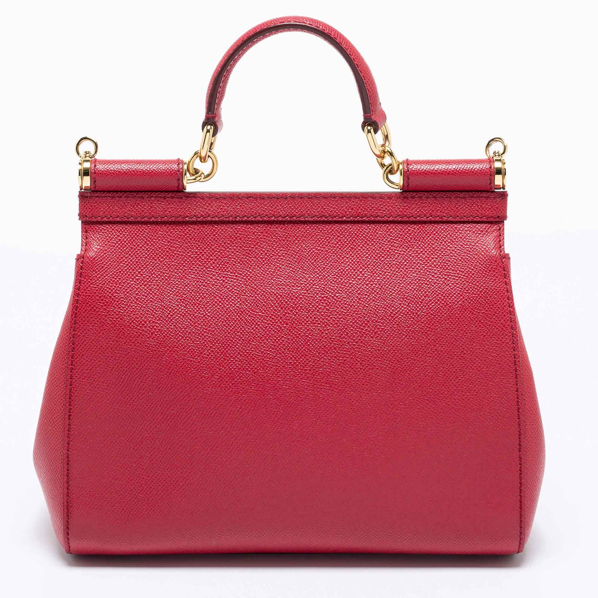 Beautiful with intricate details, this red Miss Sicily bag by Dolce & Gabbana will get you through all seasons. The exterior is made from red leather, and the bag features a top handle, shoulder strap, and a spacious interior.

Includes: Strap