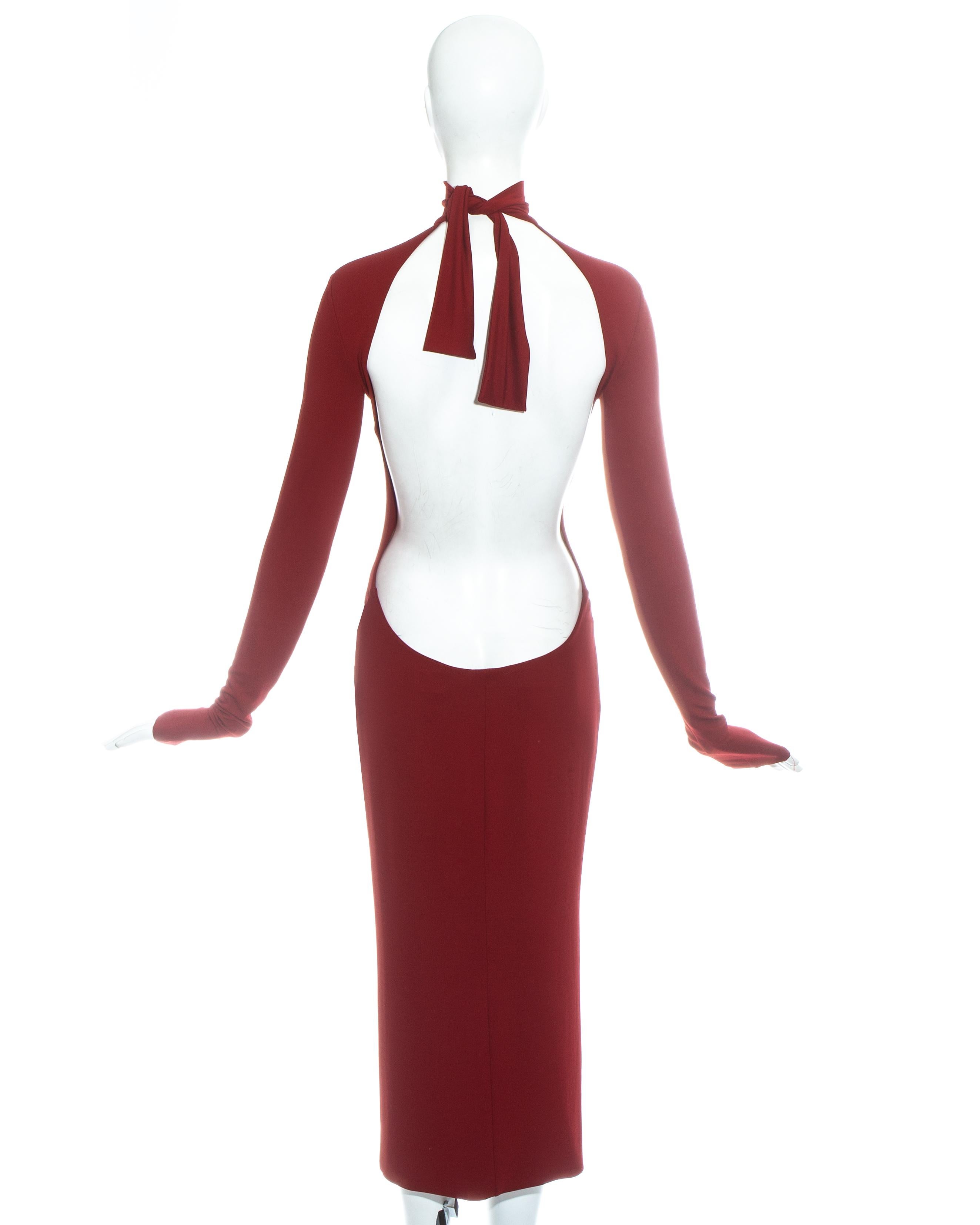 Dolce & Gabbana red figure hugging mid length turtle neck dress with very low back and tie up fastening around neck.

Spring-Summer 2001