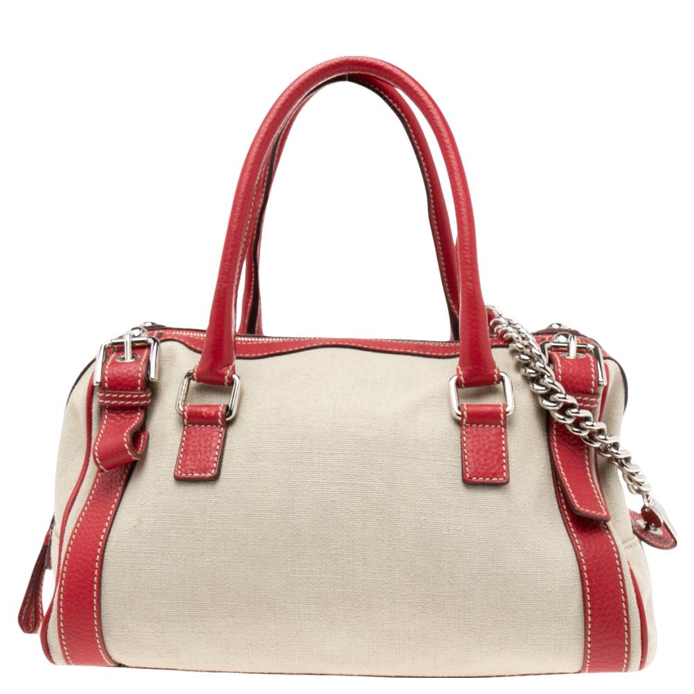 This chic Miss Easy Way Boston bag from the House of Dolce & Gabbana will complement your style perfectly. It is made from red, off-white leather and canvas on the exterior into a charming silhouette. It exhibits silver-toned hardware, a