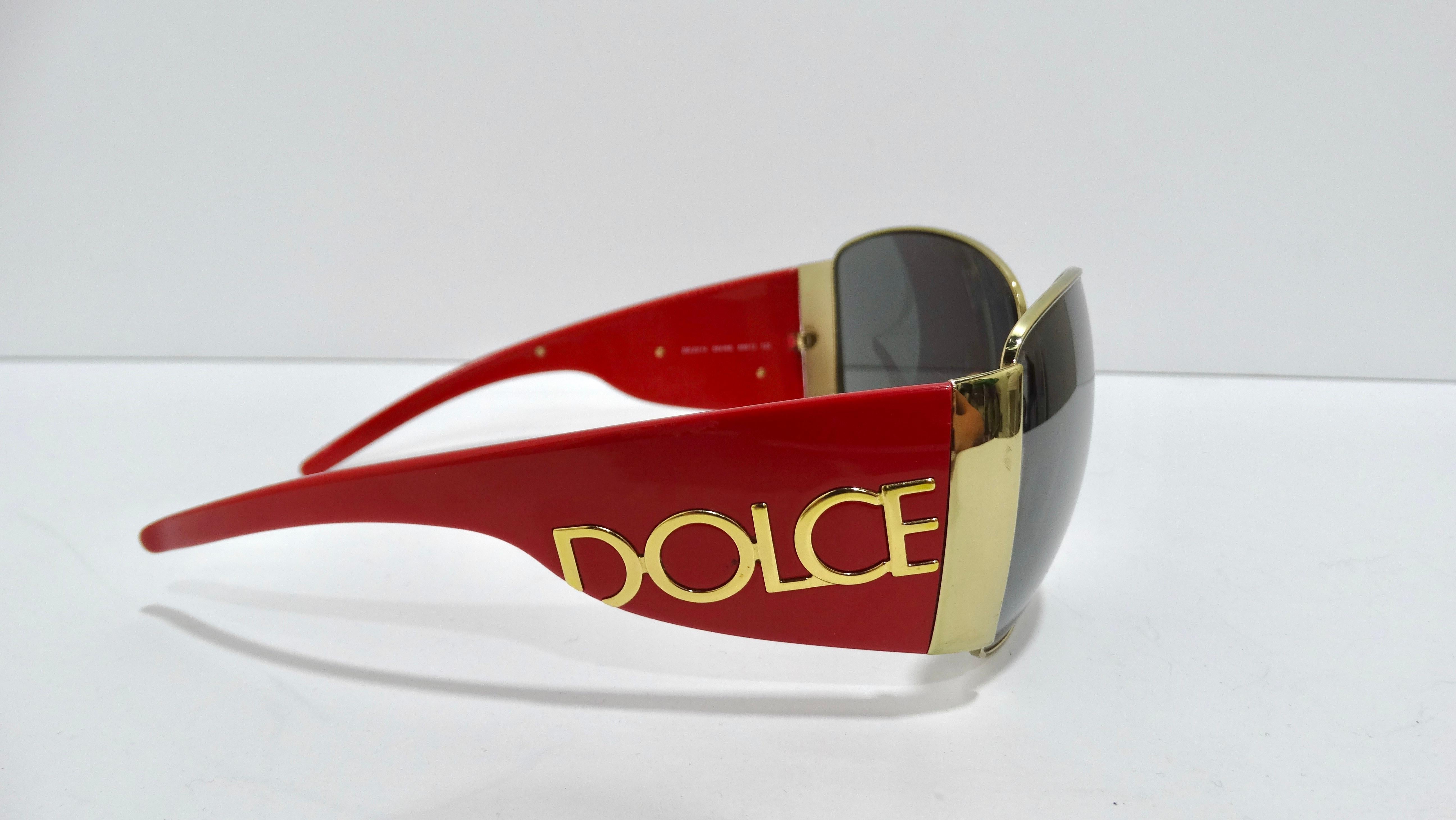 These Dolce & Gabbana sunglasses will make you the most stylish person in the room. The oversized frames and the bold branding will make a statement. These sunglasses are in a red hot color, with grey tinted lenses, 'DOLCE' in gold on the left side