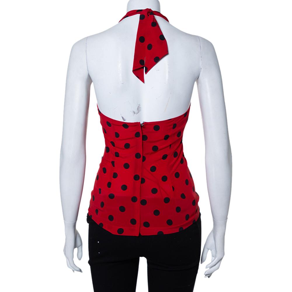 This pretty red top from Dolce & Gabbana is here to make you look fashionably divine. Made from stretch silk, the top has a halter neck, a zip closure, and polka dots all over. You can wear it with jeans or skirts.


