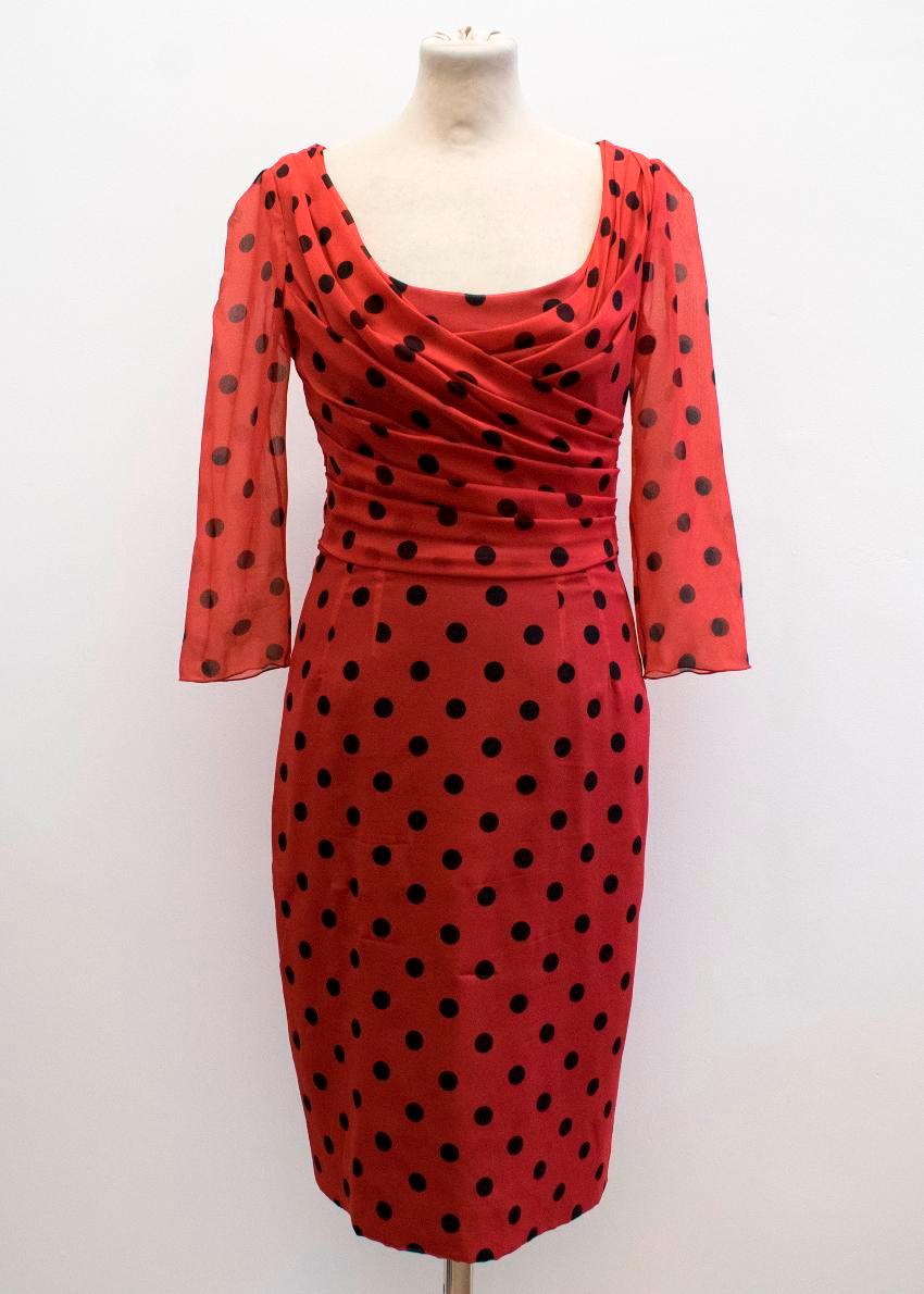 Dolce & Gabbana red polkadot dress in a chiffon overlay style featuring a scoop neckline, three-quarter length sleeves and ruched bodice detail. Lined with black stretch silk.

* Please note, these items are pre-owned and may show signs of being