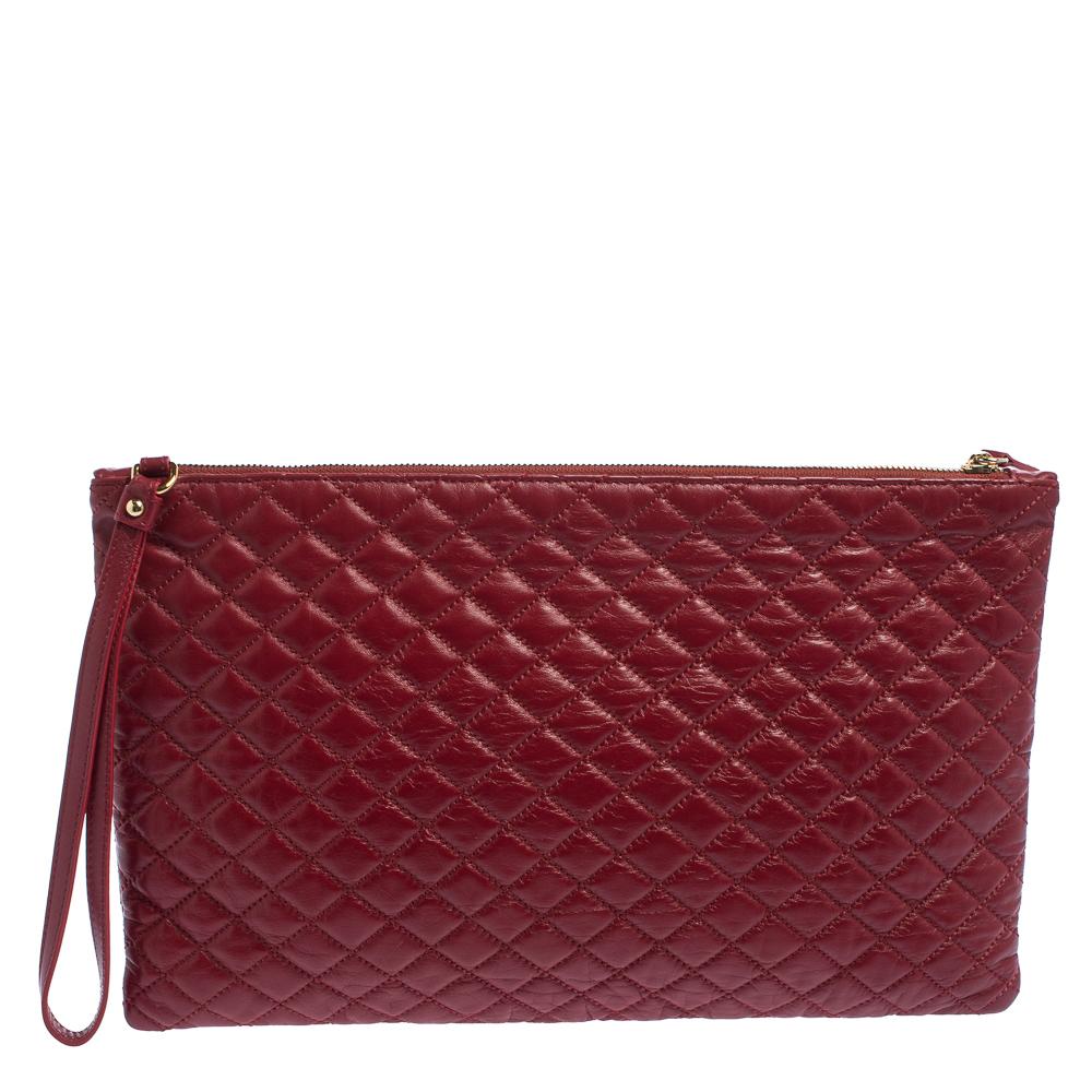 This women's pouch from Dolce & Gabbana has been made using quilted leather in Italy. It has a striped interior lined with fabric and secured by a top zip closure. The handy pouch has a simple shape and a wristlet.

Includes: Original Dustbag
