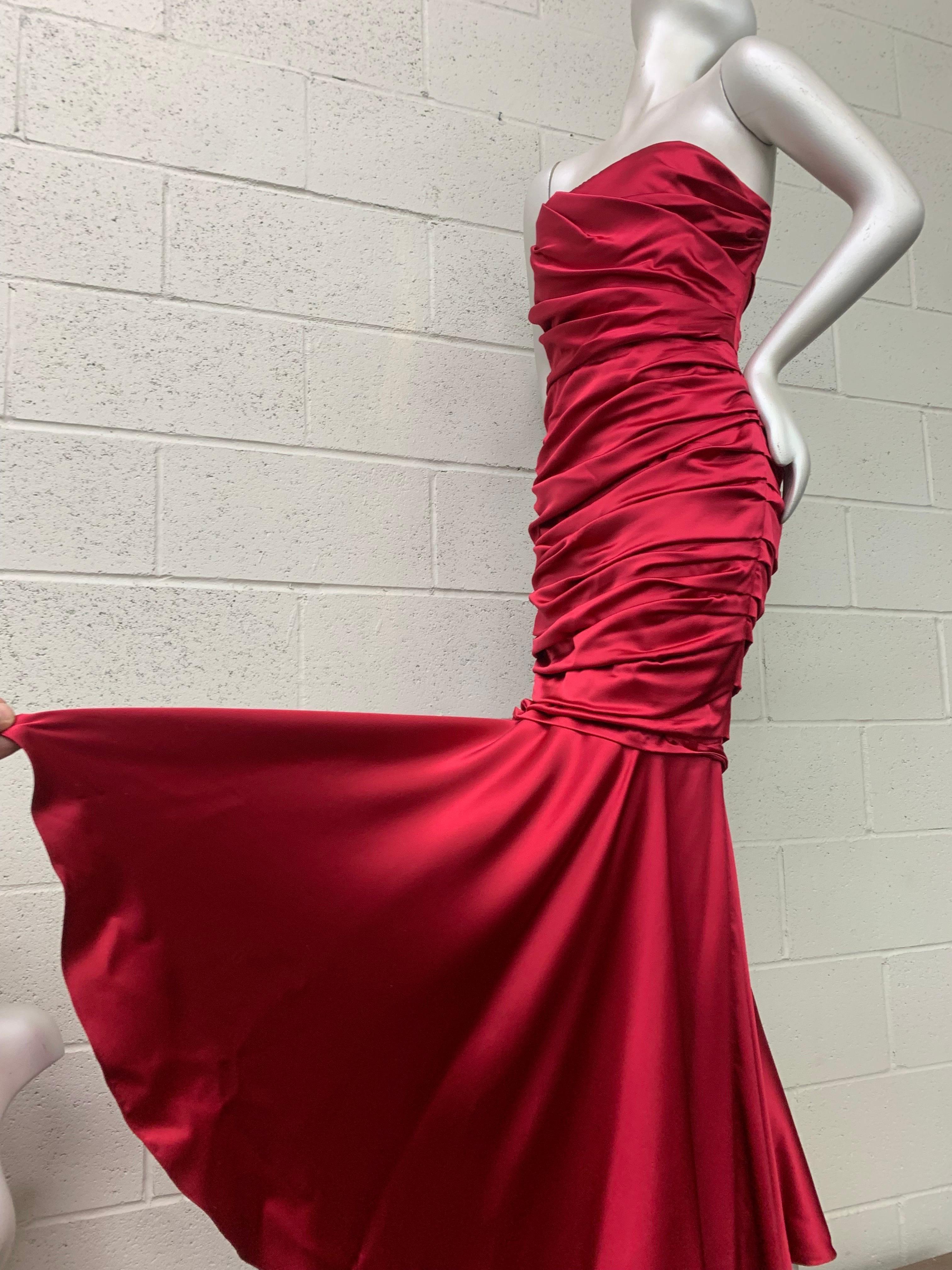 Dolce & Gabbana Red Satin Strapless Corset Gown w Fishtail Hem & Ruched Bodice. Fully boned and structured inner corseting details and a beautifully fluid and lush bias-cut hemline. Back zipper. Fully lined. New, never worn. Size 44. Monogrammed