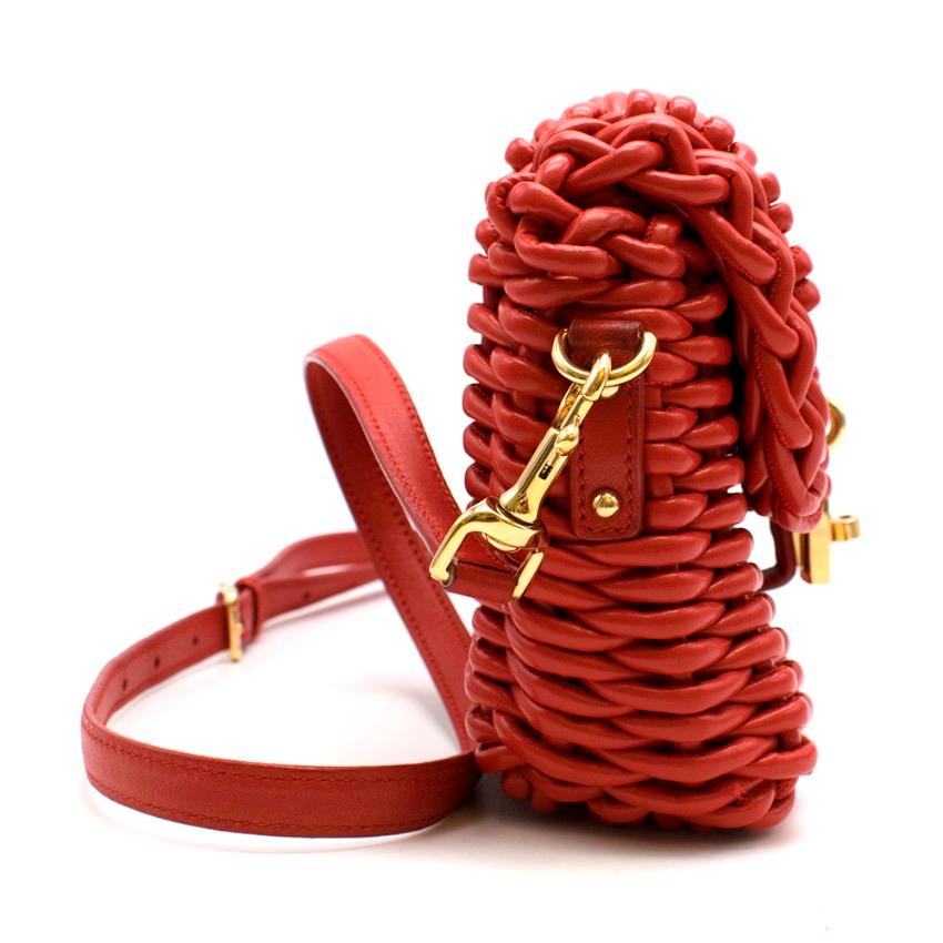 Dolce & Gabbana Red Woven Leather Bag 
- Red woven basket style 
- Gold-tone padlock with twist lock on the front 
- Red leather details and strap 
- Gold-tone hardwear 
- Leopard lining with inside zip pocket 

Materials
- Leather
- Gold-tone metal