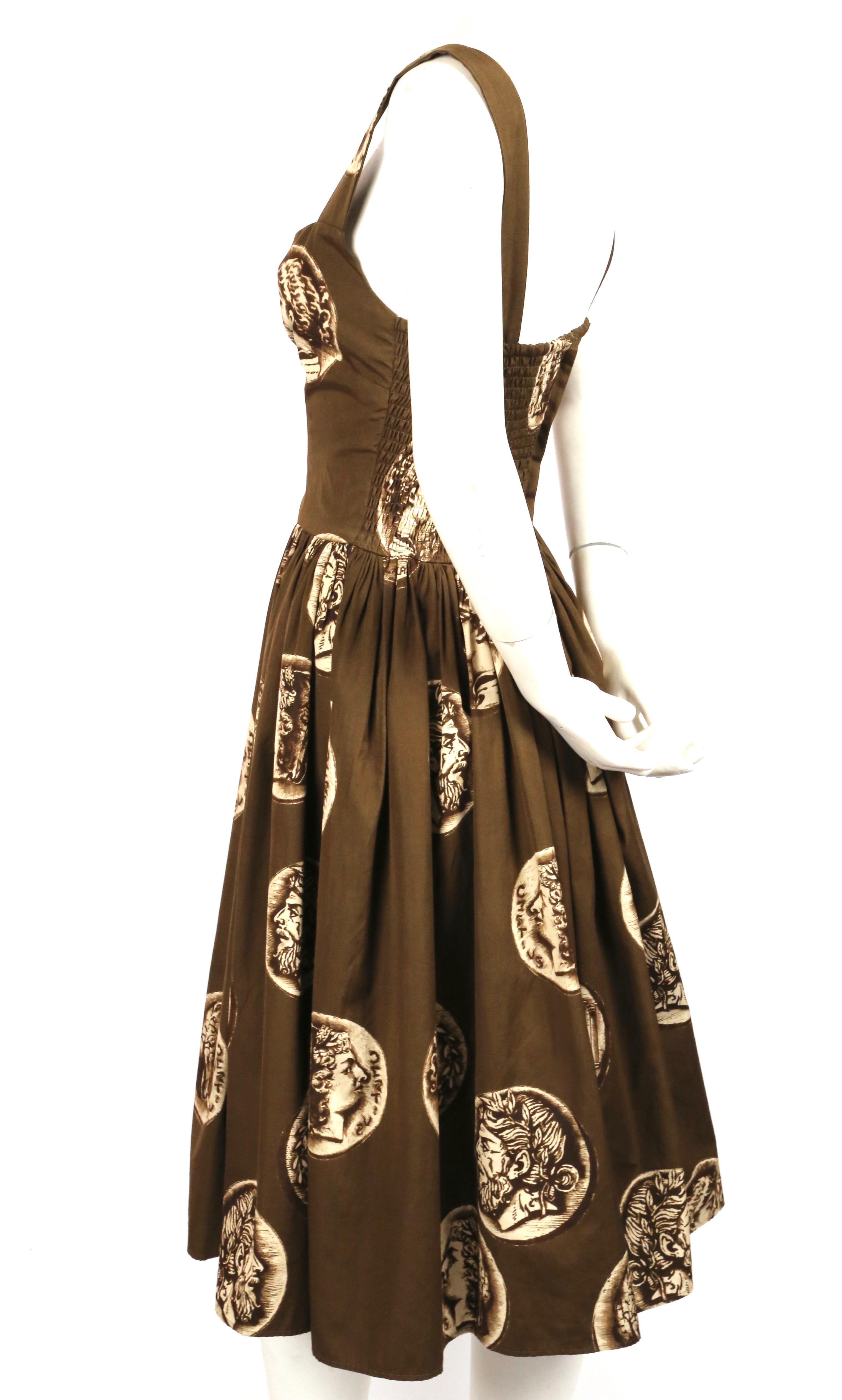Brown, medallion printed cotton dress designed by Dolce & Gabbana. Dress was originally labeled an Italian size 44 however it has been altered to a 40/42. Approximate measurements (un-stretched): bust 31