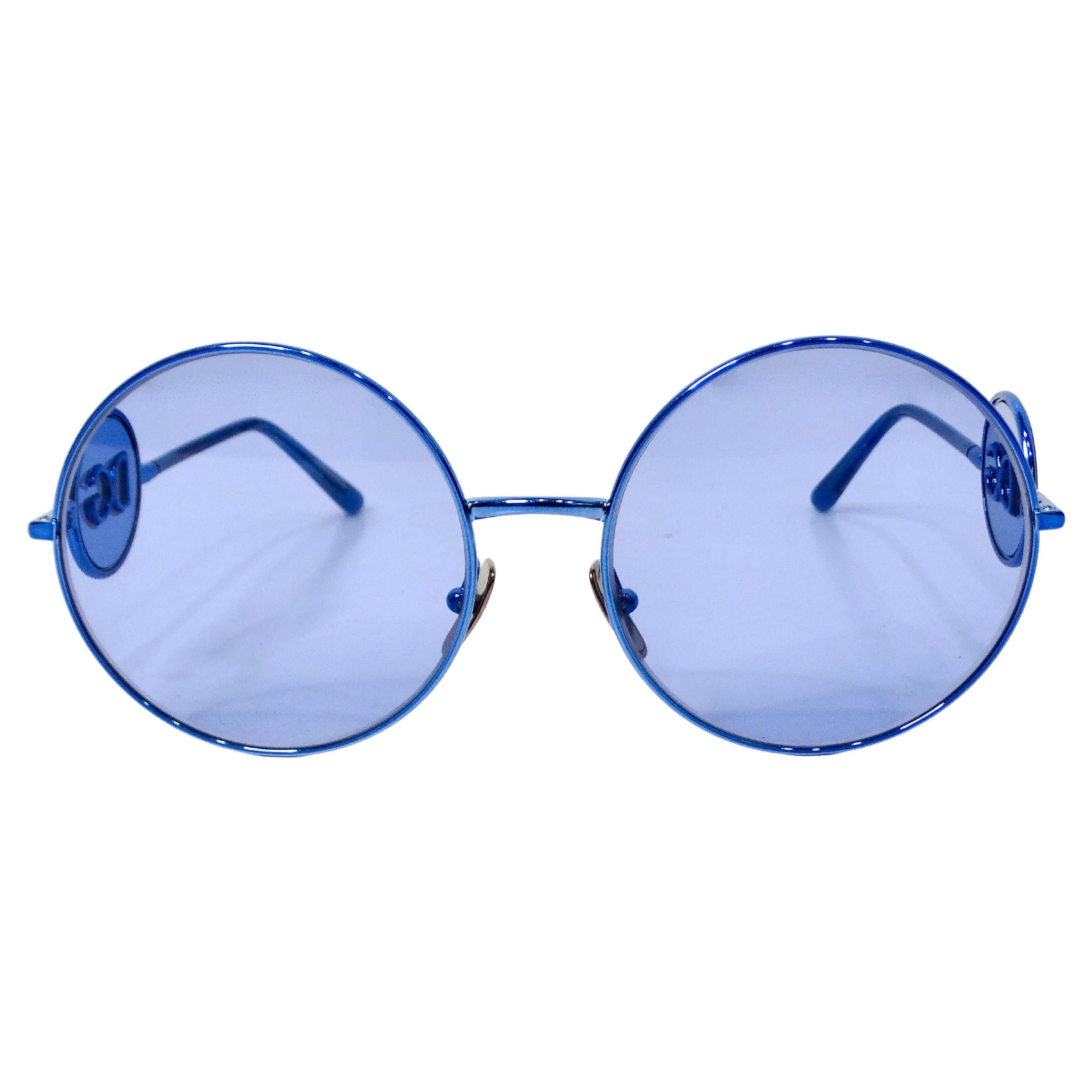 The Dolce & Gabbana Round Blue Metal Frame DG Sunglasses epitomize sophisticated luxury and contemporary style. Crafted with a sleek round blue metal frame, these sunglasses exude modern elegance while offering a striking pop of color that