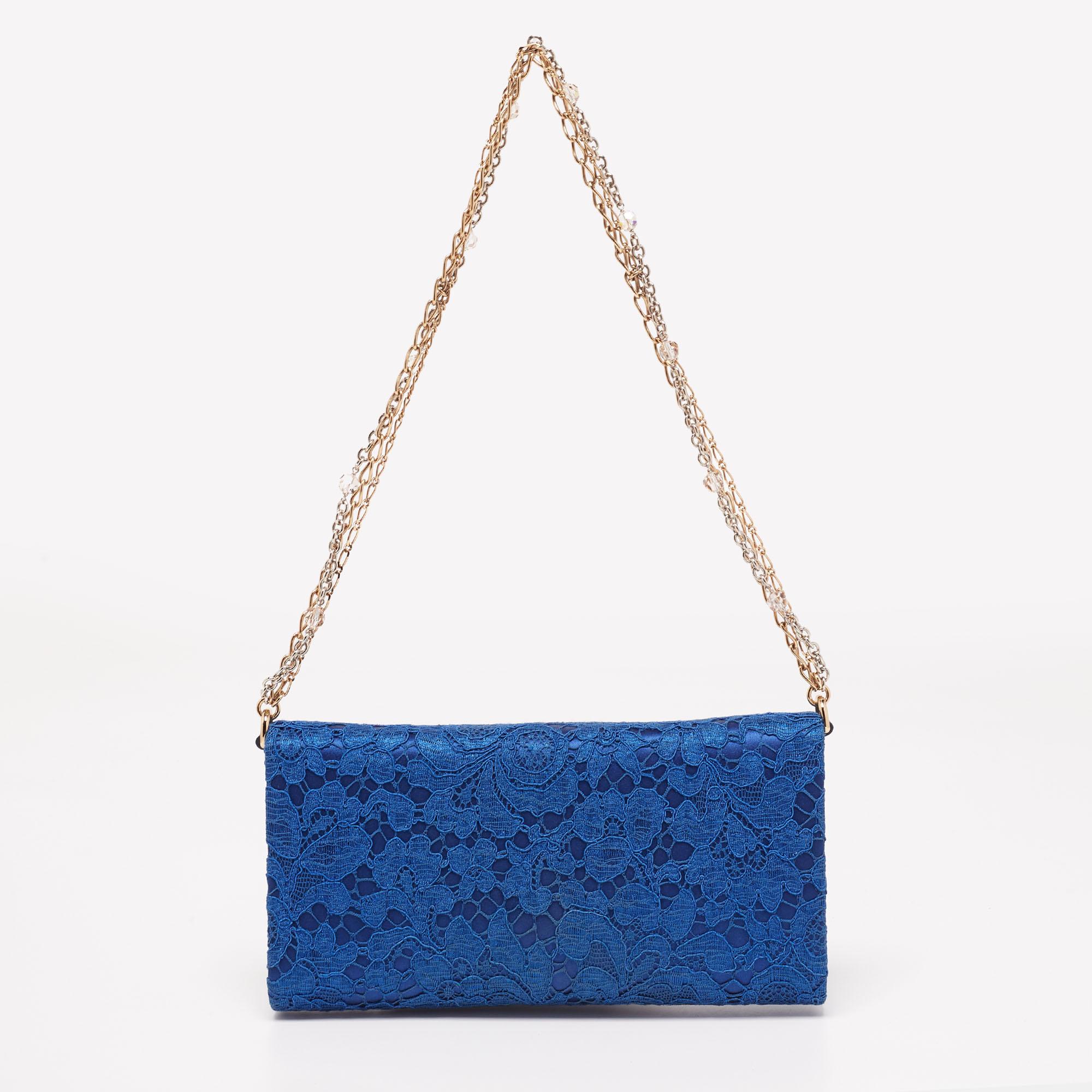 Dolce & Gabbana is known for its outstanding designs, just like this stunning royal blue clutch. A fresh take on elegance, this chain clutch is crafted from lace and satin and flaunts a pretty padlock on the front. It is perfect to complete your