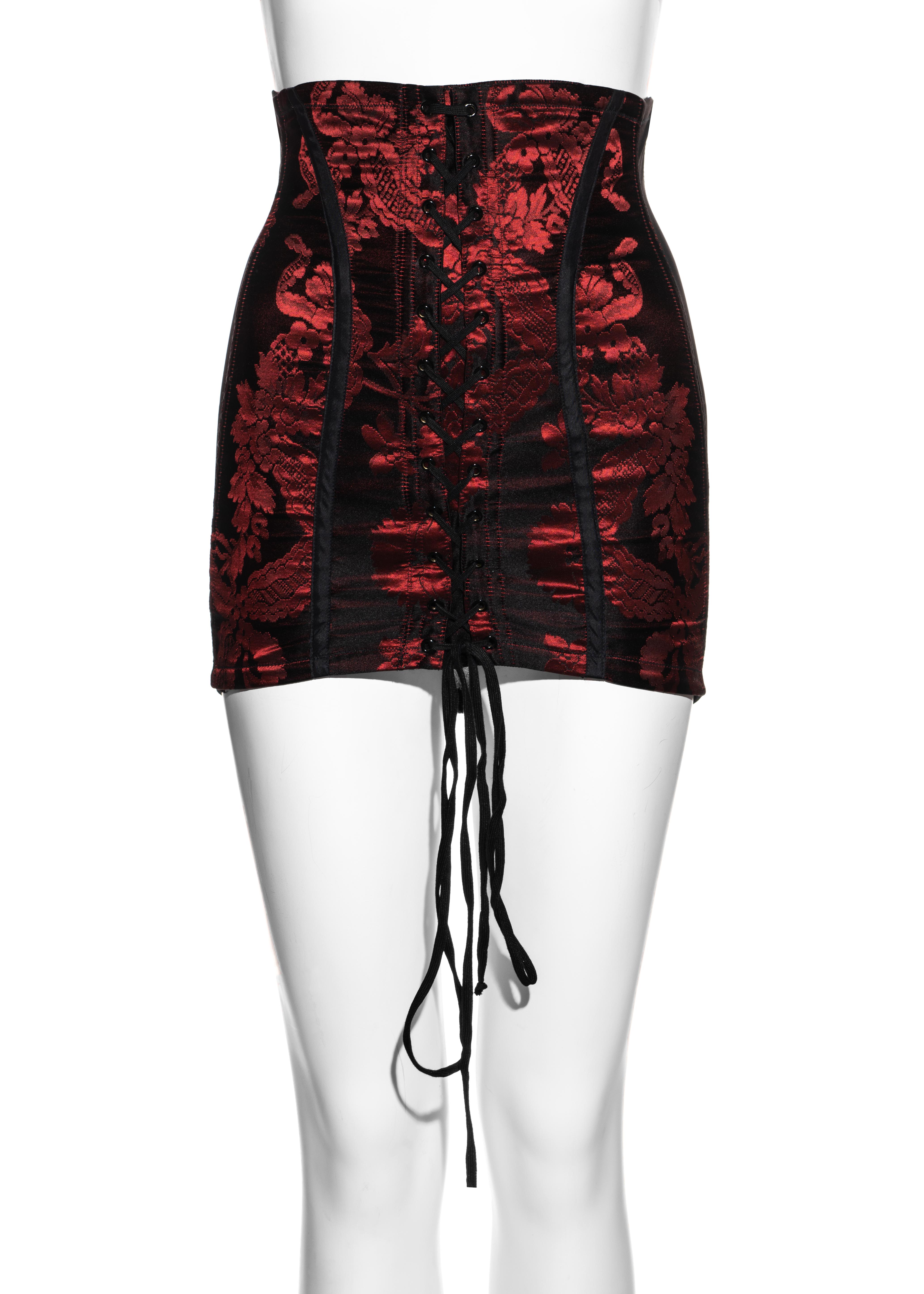 ▪ Dolce & Gabbana ruby brocade corseted micro mini skirt
▪ Girdle style 
▪ Lace up fastening at centre front
▪ Metal hook closures at centre back
▪ Black spandex back panel 
▪ IT 40 - FR 36 - UK 8 - US 4
▪ Spring-Summer 1993