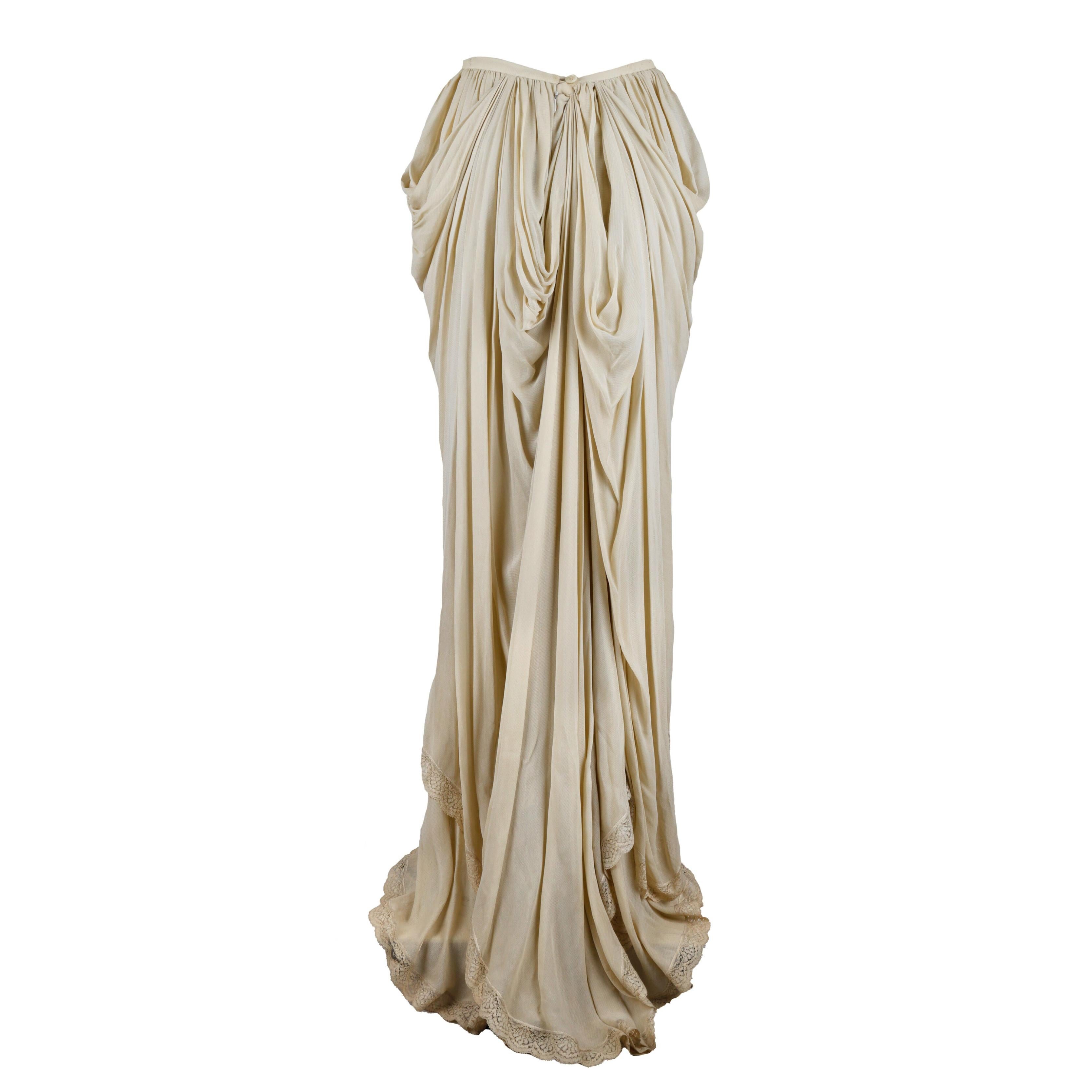 This Dolce & Gabbana Ruched Layer Skirt is crafted from a viscose blend in a light beige shade, featuring lavish ruches and layers that evoke the look of Roman sculptures. With delicate lace trimming at the hem, this one-of-a-kind skirt will give
