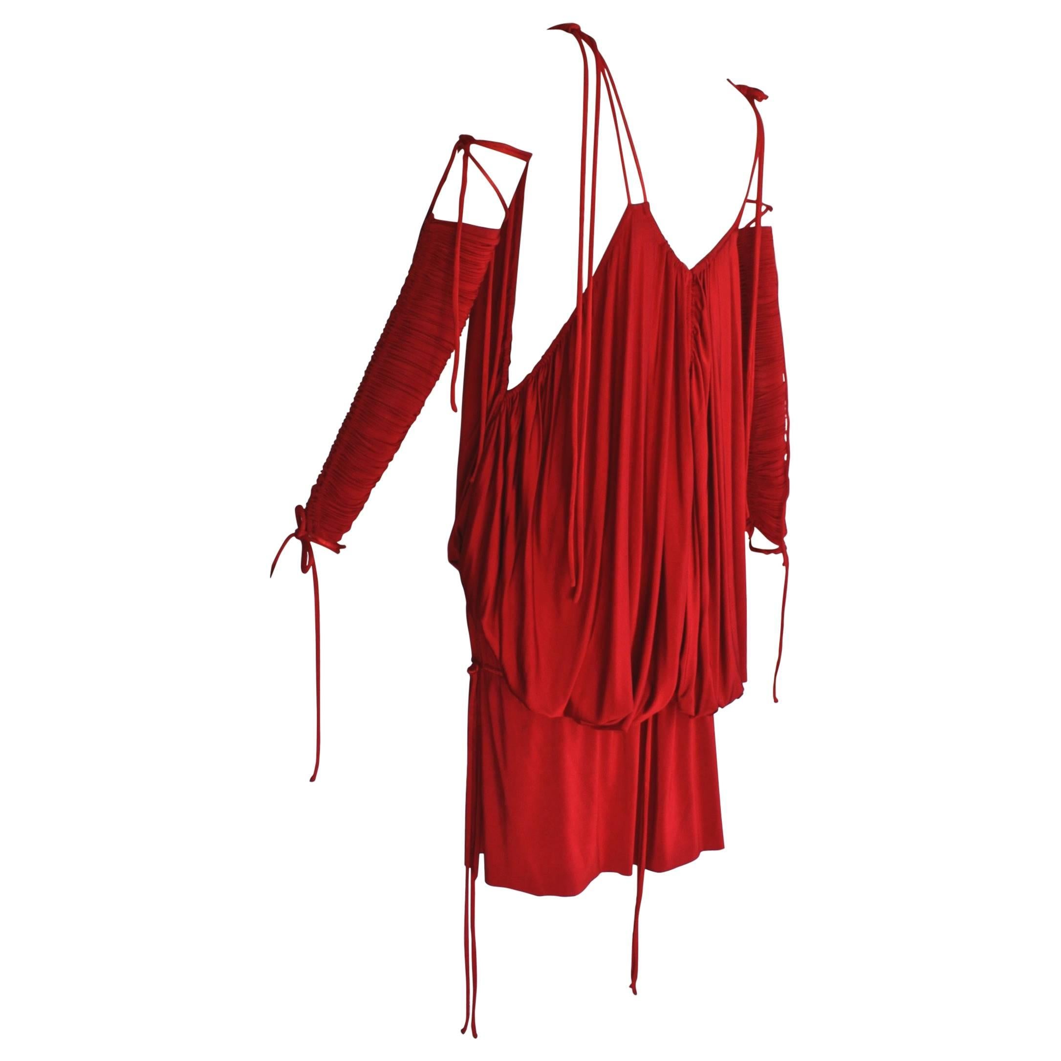 Red, baring and slinky, this Dolce & Gabbana minidress is designed to command attention. When it debuted in the spring/summer 2003 runway show on supermodel Gisele Bündchen, it led Vogue’s Sarah Mower to write, “power-womanhood is not extinct on