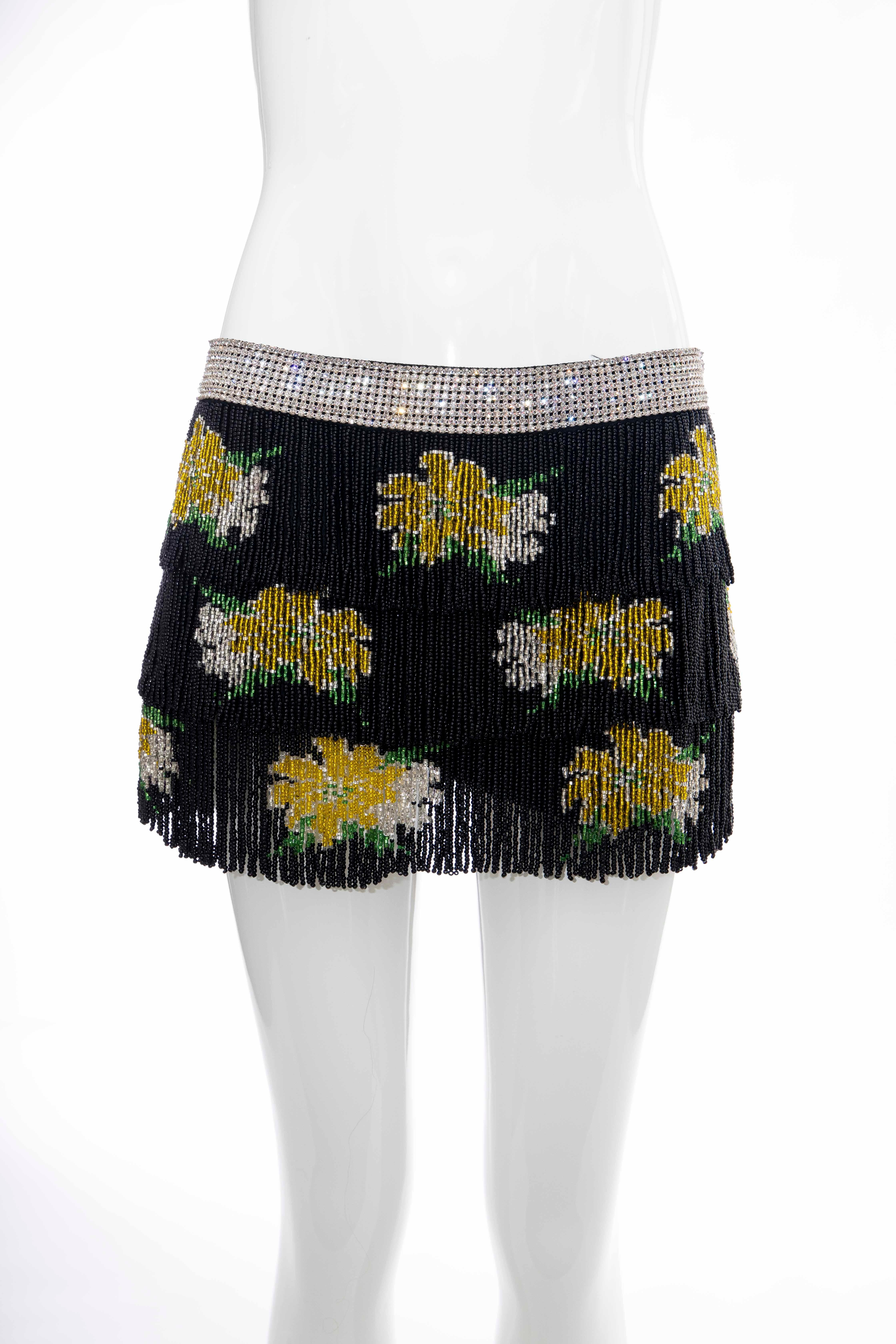 Dolce Gabbana, Runway Spring-Summer 2000, black silk mini skirt with diamanté waistband, three tiered black beaded fringe, zip closure at side and fully lined in silk.

IT. 38, US. 2

Waist: 29, Hip: 34, Length: 11

Fabric: 100% Silk; Lining 100%