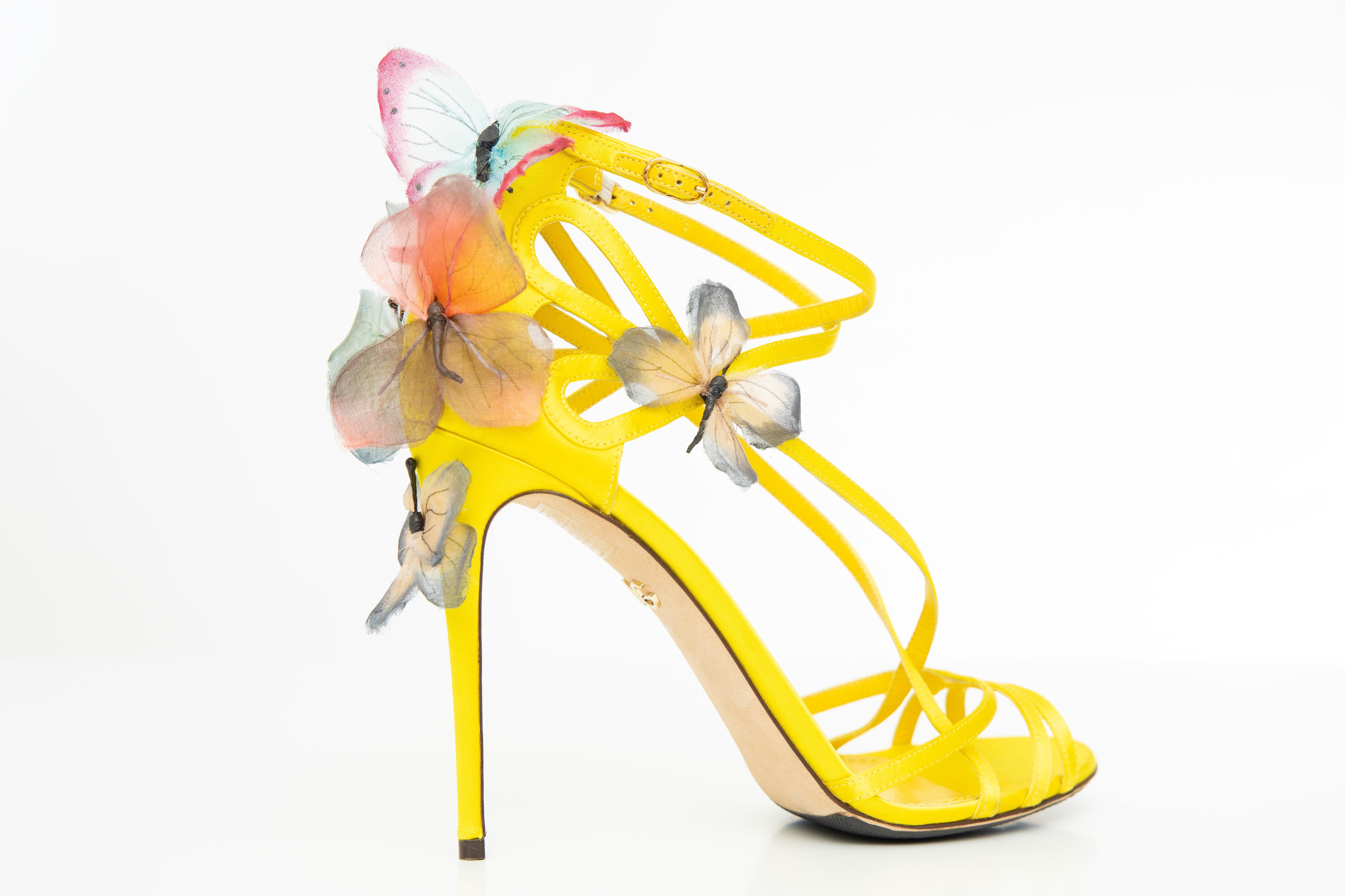 Dolce & Gabbana Runway Spring 1998,  yellow silk satin sandals with butterfly appliqué at counters, gold-tone buckle closures at ankle straps, tonal stitching throughout and covered heels. 

IT. 39, US. 9
Heels: 4.5