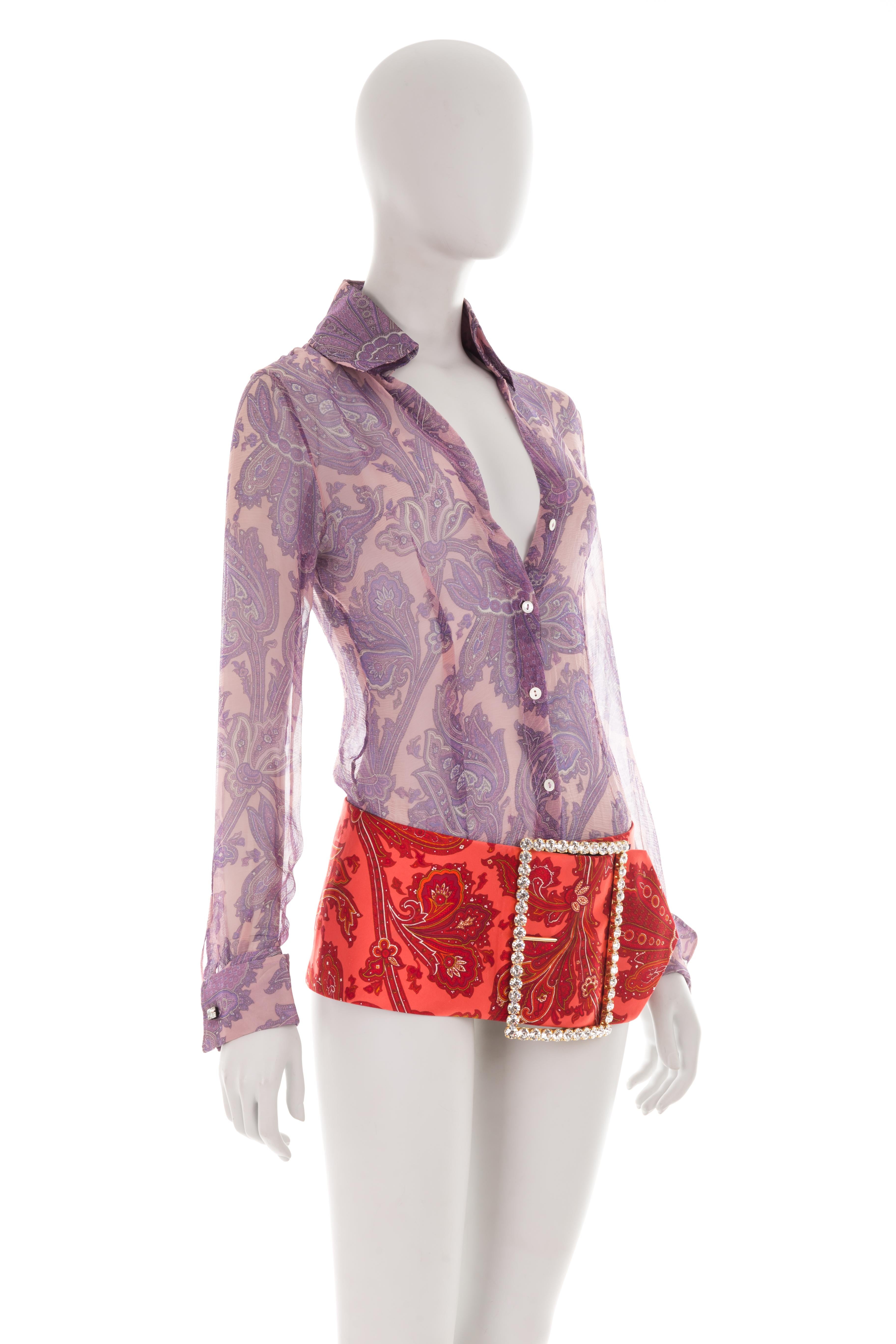 - Spring- summer 2000 “Mix & Match” collection - Sold by Gold Palms Vintage
- Purple silk low plunge shirt
- Swarovski cuffs
- Red paisley micro skirt
- Chunky Swarovski buckle
- Velcro strap closure
- Seen on Look 34, worn by Trish Goff - Size: IT