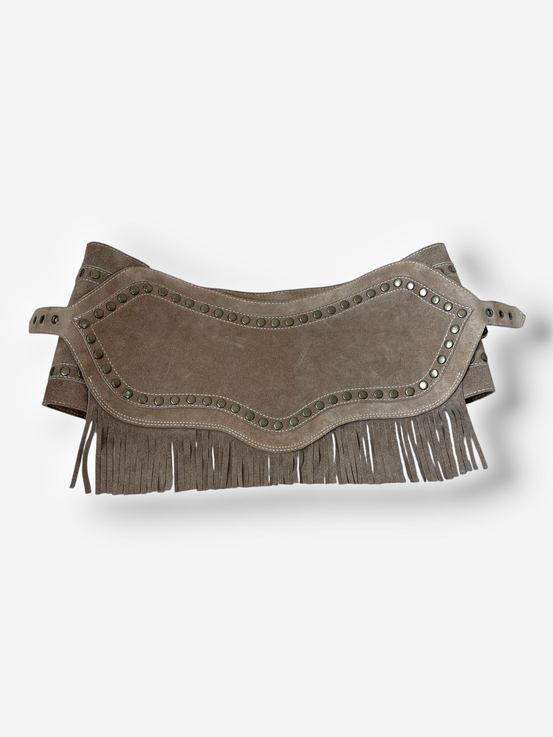 
A standout micro-mini skirt—or statement belt—direct from Dolce & Gabbana’s Spring/Summer 2010 collection. Crafted from tan suede, it features cascading fringe, bronze hardware, and all-over stud detailing. The skirt fastens with snap buttons and