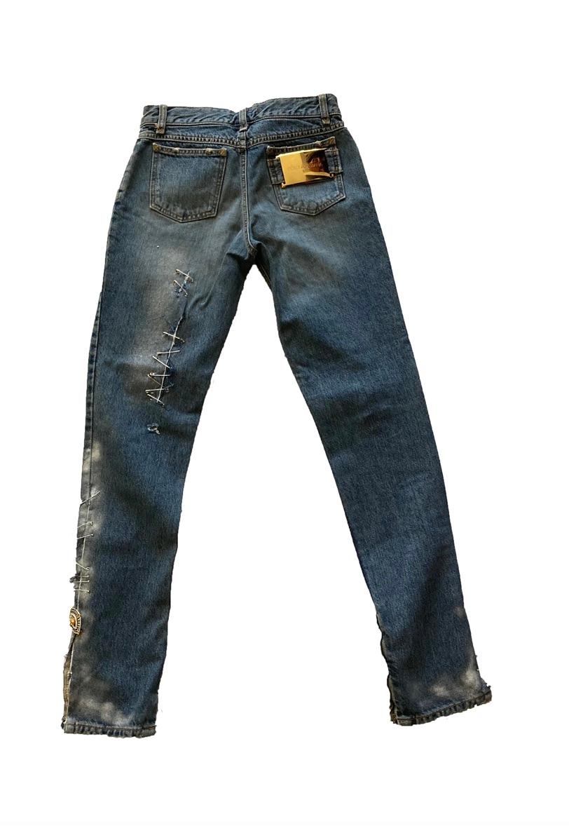 Safety pin jeans from Dolce & Gabbana. Light wash denim skinny jeans embellished with safety pins fastening frayed rips up the front and reverse of jeans. Slight faded effect around the ankles. With black jewelled spider brooch and amber toned