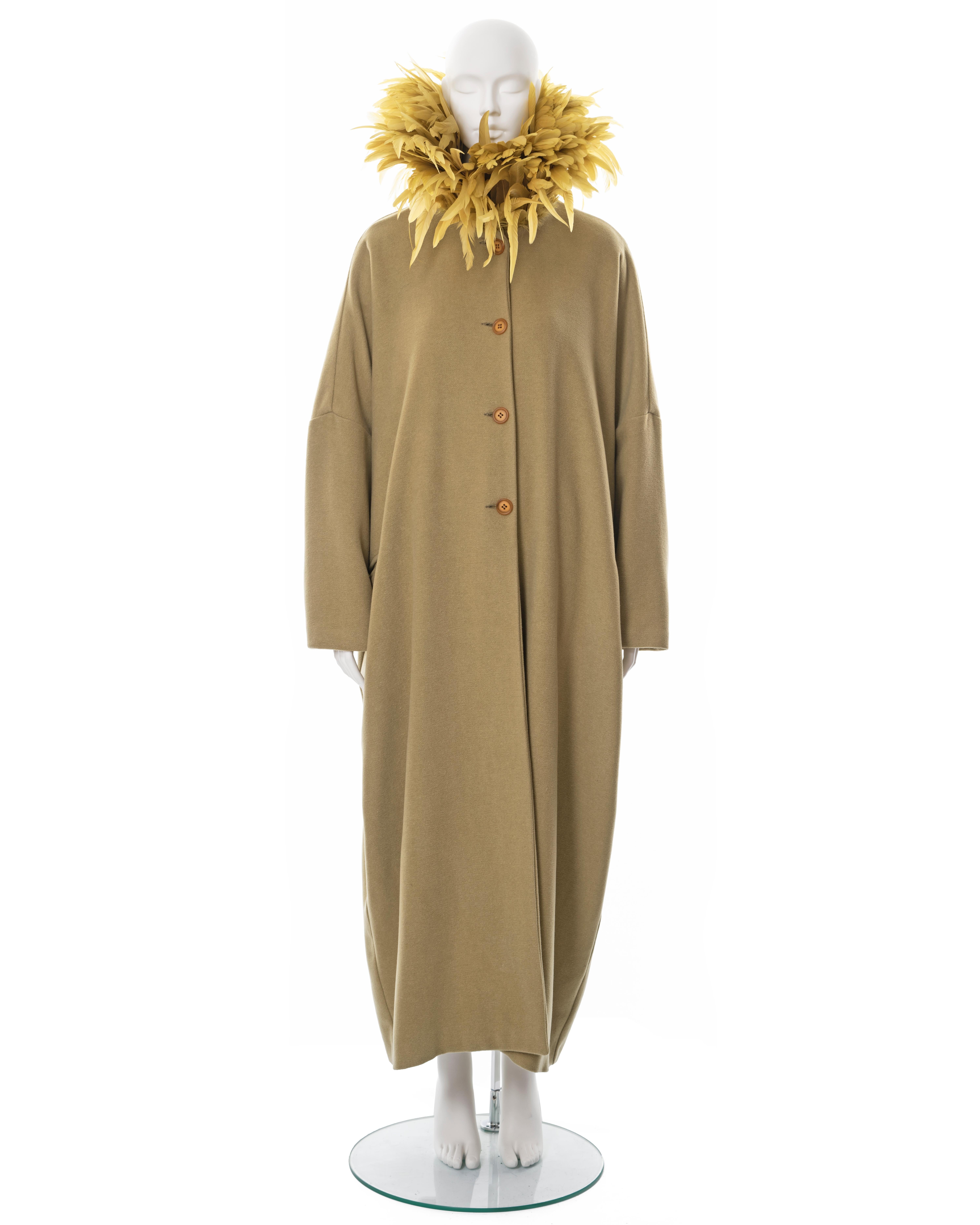 ▪ Dolce & Gabbana sage green wool coat 
▪ Fall-Winter 1990
▪ Collar embellished with yellow feathers 
▪ Cocoon fit 
▪ Dropped shoulder 
▪ Front button closures 
▪ Ankle length 
▪ Sample; has the hand-written fabric label from the Atelier 
▪ One Size