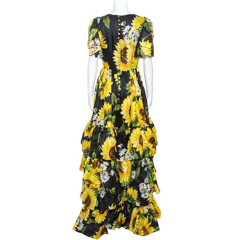 Extravagance meets great tailoring in this dress from Dolce & Gabbana. The beauty of a piece is made from quality silk and designed with short sleeves, tiered ruffles and blooming sunflower prints all over. The dress is enhanced with embellishments