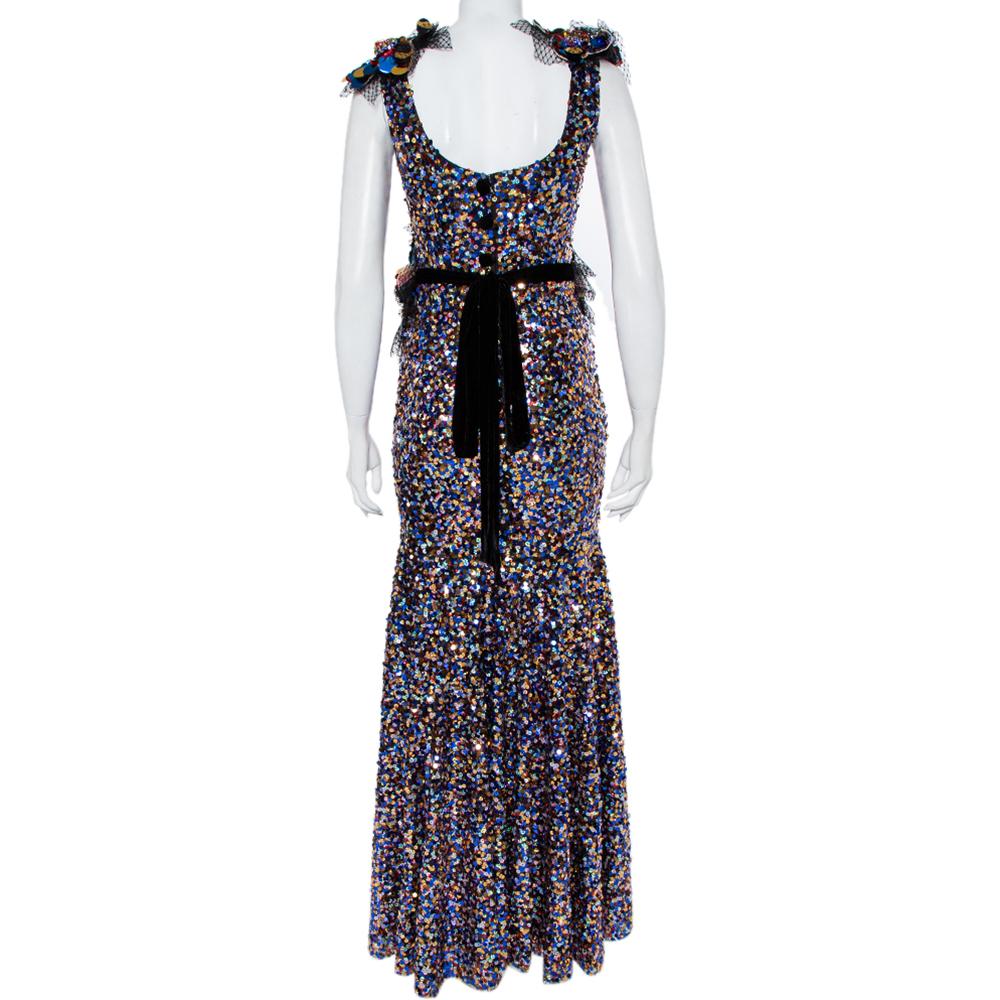 You're all set to dazzle with this gown from Dolce&Gabbana. Decorated with sequins all over, the multicolored dress carries a sleeveless, mermaid style with a back zipper and a hem ending below the ankles. It'll look enchanting with a pair of shiny