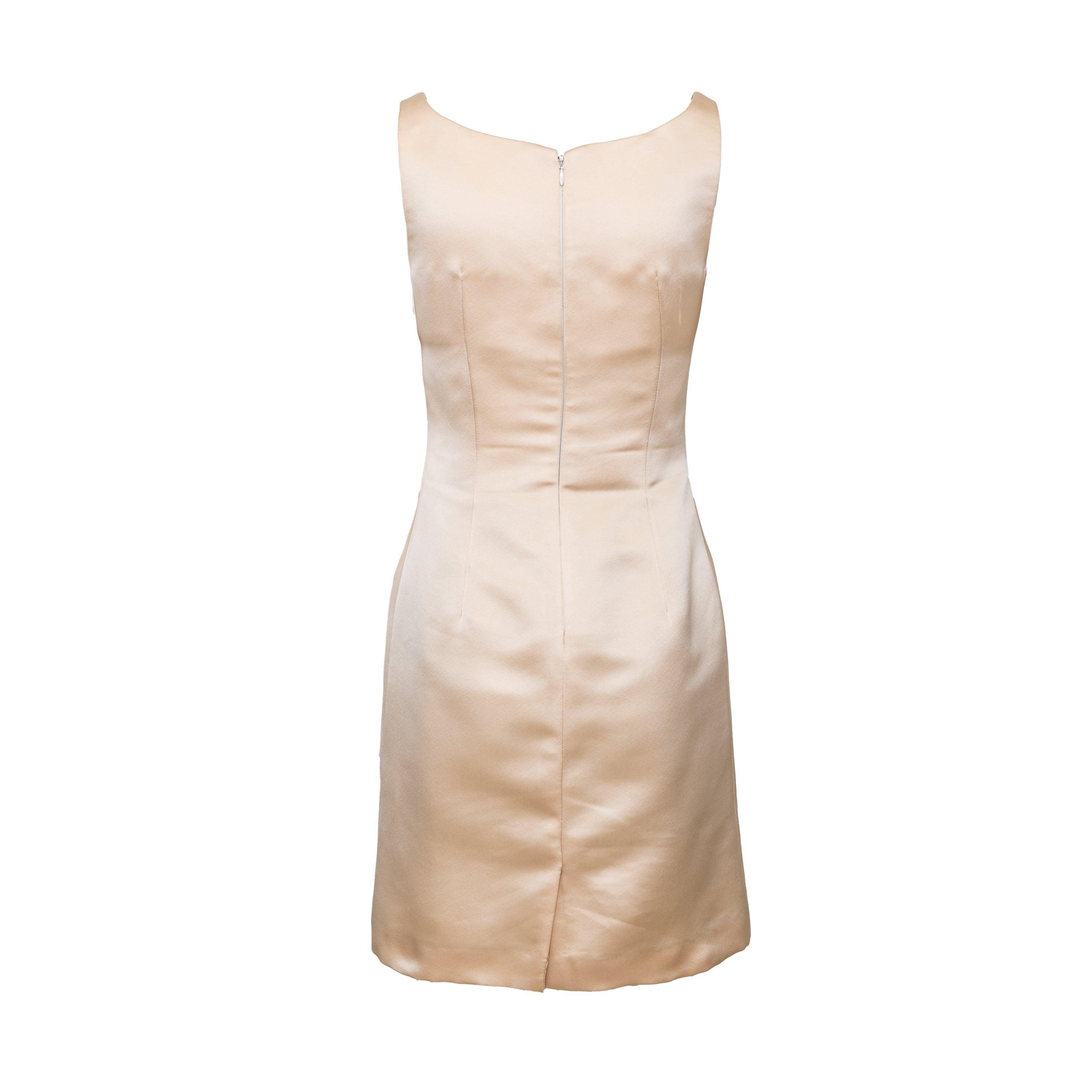 Elevate your wardrobe with this Dolce & Gabbana Satin Dress. Crafted from luxurious 100% silk in a light beige hue, this midi dress features a sleeveless, deep neckline and thin shoulder straps. Its fitted silhouette is enhanced by feminine pleats,