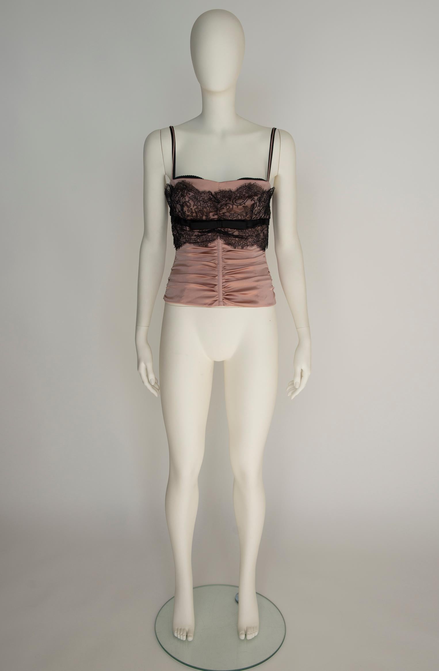 Probably from the iconic 2001 Spring-Summer collection, this Dolce & Gabbana corset bustier top will for sure enhance your femininity ! Made from glossy powder pink satin, it's designed with boning to offer structure and shape. Softly gathered
