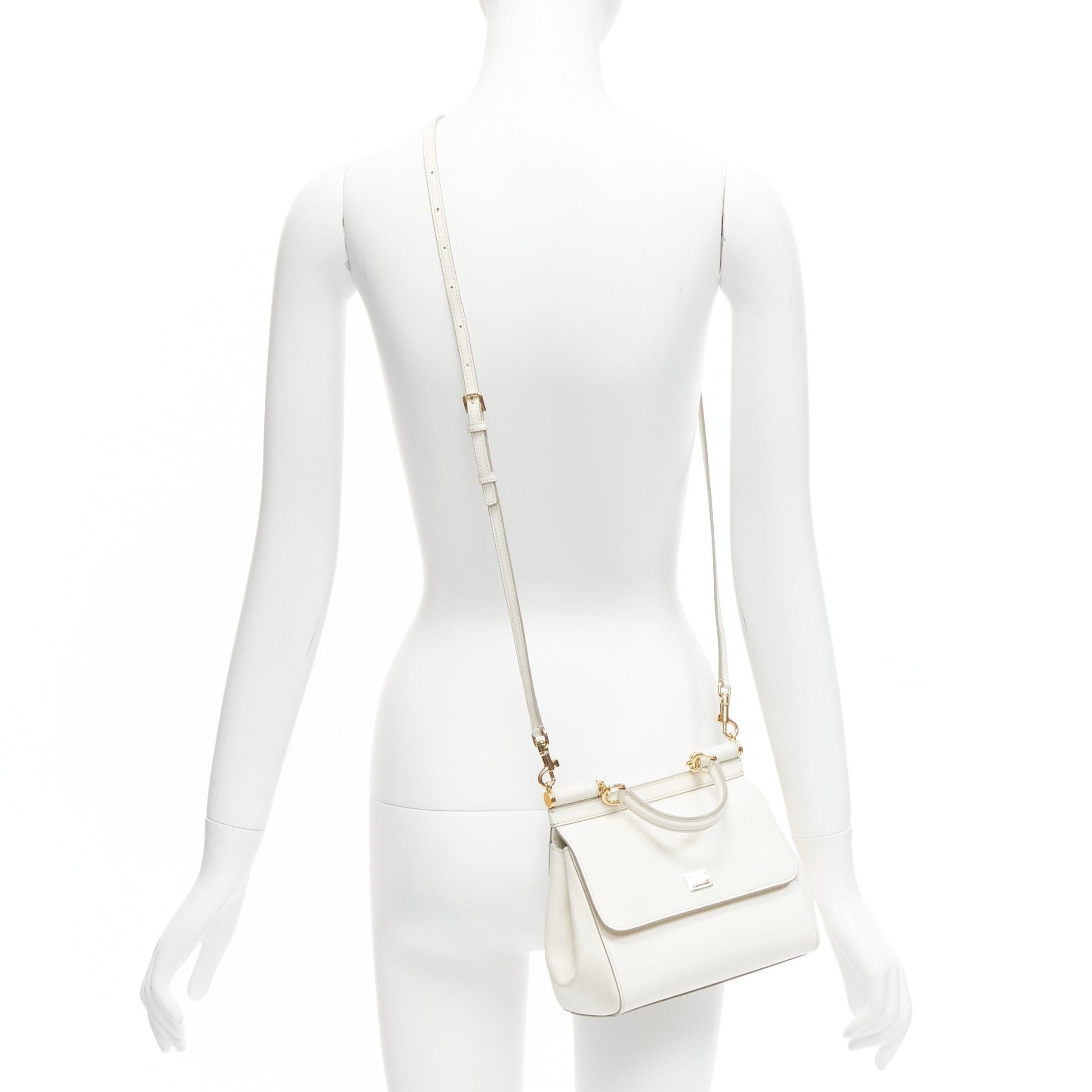 DOLCE GABBANA Sicily Small white leather top handle flap crossbody bag
Reference: TGAS/D00776
Brand: Dolce Gabbana
Designer: Domenico Dolce and Stefano Gabbana
Model: Sicily
Material: Leather
Color: White
Pattern: Solid
Closure: Snap Buttons
Lining: