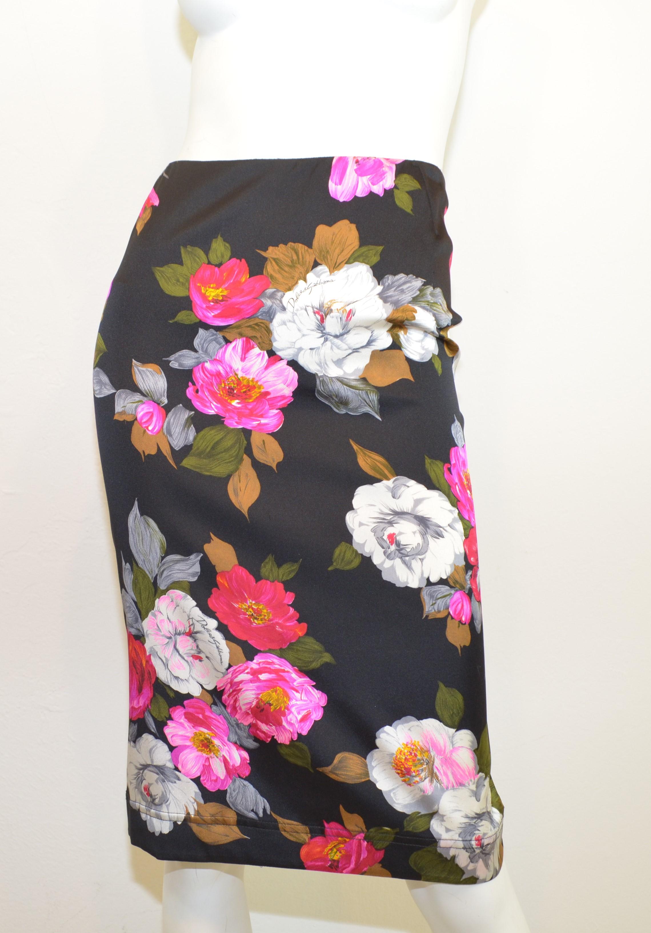 Dolce & Gabbana Silk Pencil Skirt w/Floral Print -- skirt features a multicolored floral print on a black background. Skirt has a back zipper and hook-and-eye fastening, size 46,  and composed with a silk and lycra blend.

Measurements:
waist