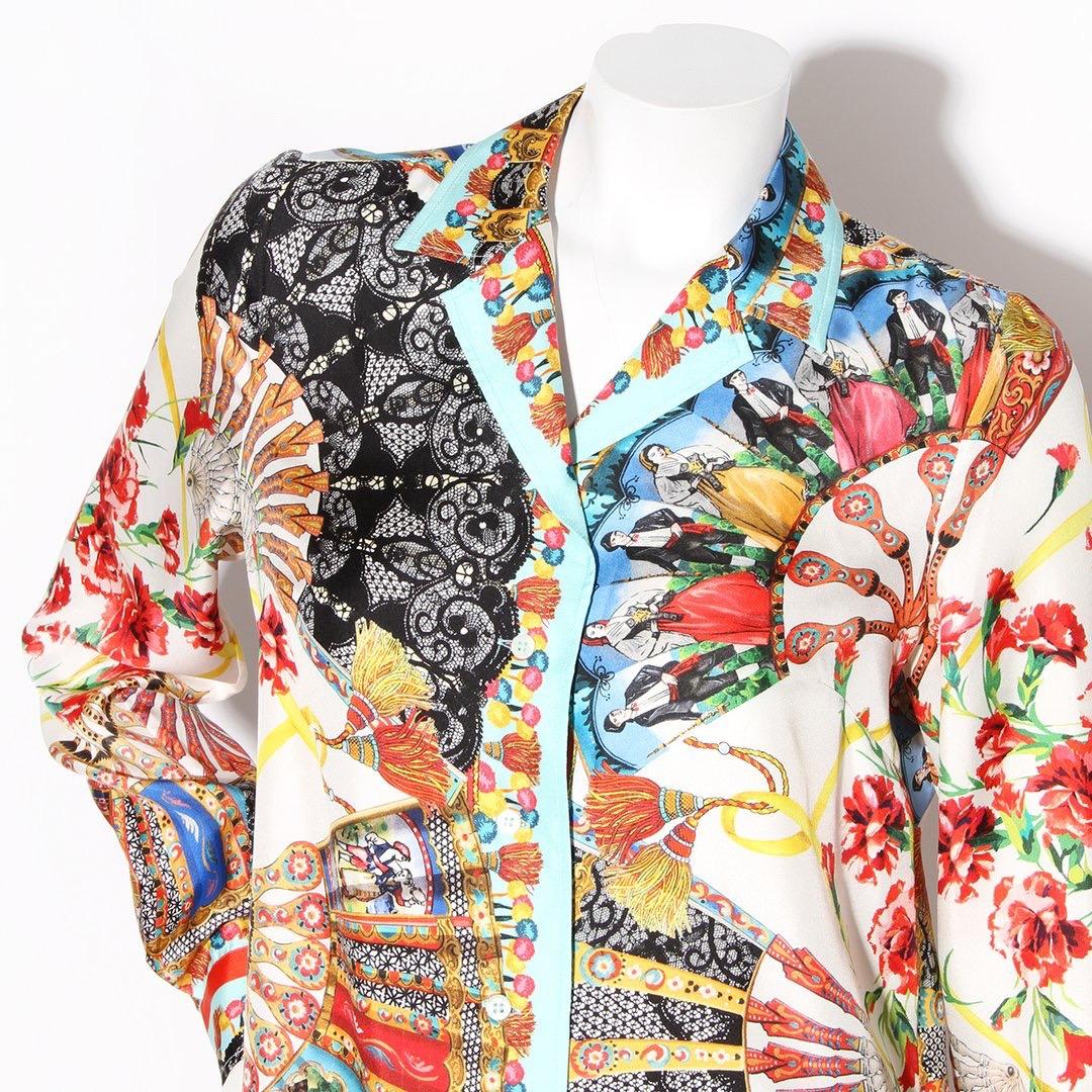 Product Details:
Silk print pant suit by Dolce & Gabbana 
Multicolor print 
Fan print with Sicilian figures 
Blouse:
Pointed collar
Long sleeve 
Button closure cuffs
Button front closure
Fluid silhouette
Pant:
Mid rise
Flat front
Fitted legs
Zip