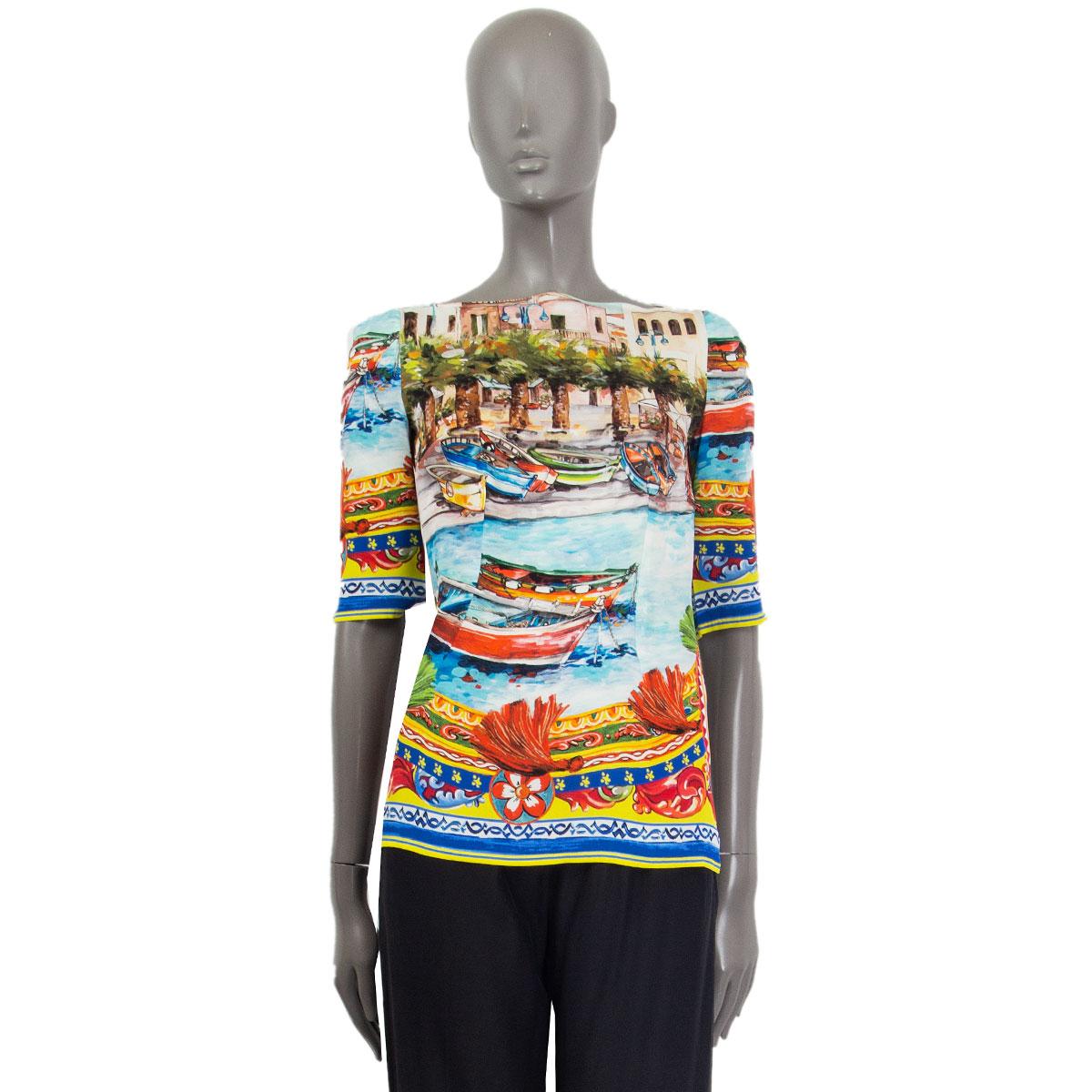 100% authentic Dolce & Gabbana Sorrento printed 3/4 sleeve blouse in yellow, orange, red, green, olive green, blue, light blue, grey and off-white silk (94%) and elastane (6%). Opens with a zipper on the back. Has been worn and is in excellent