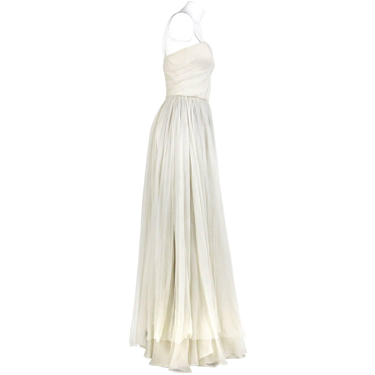 Beautiful Dolce & Gabbana wedding dress in ivory white silk tulle veil. It features beaded shoulder straps, sweetheart neckline, a wide skirt and zip closure on the back. The item is vintage, it was produced in the 2000s and is in very good